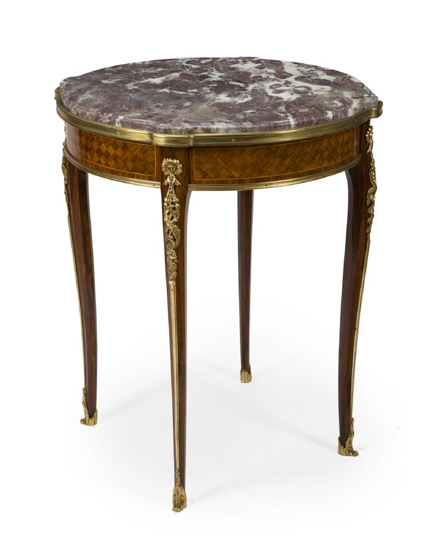 A François Linke gueridon table: Late 19th/early 20th century Signed: F. Linke The round marble top over a parquetry apron issuing four tapered cabriole legs set with gilt bronze mounts 30" H x 25.25" W x 25.25" D
