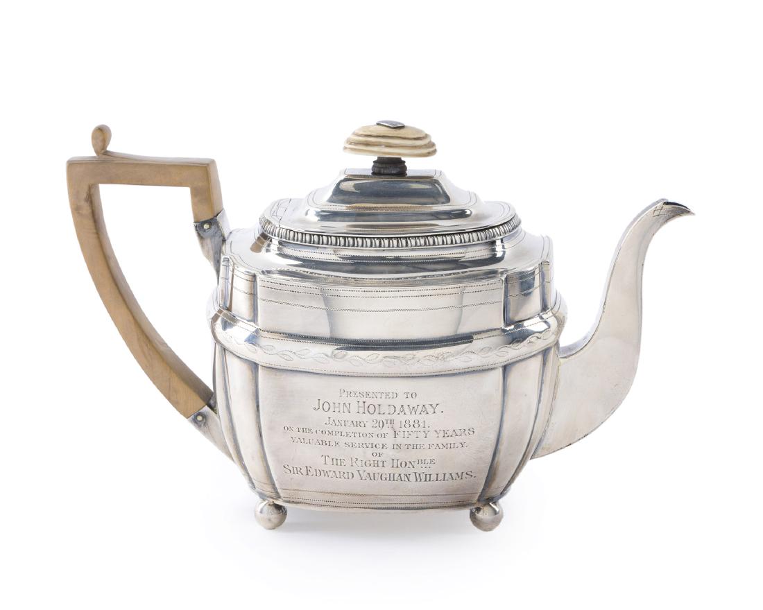 An English George III sterling silver teapot: 1806, London Stamped for William Bateman II The bone finial over a rounded rectangular body with gadrooned edge and chased decoration raised on ball feet, inscribed to body: Presented to John Holdaway