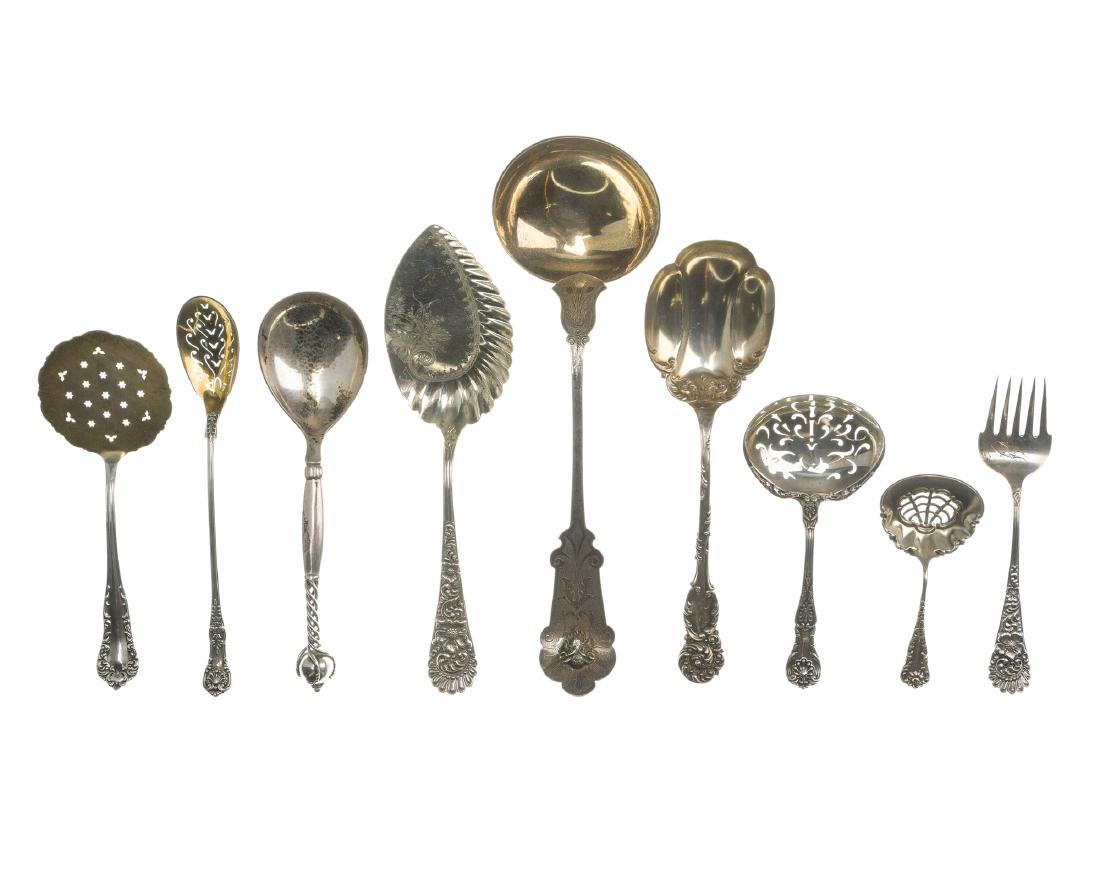 A group of sterling and coin silver items: Comprising two matching sets of demitasse spoons, sterling silver serveware, souvenir spoons, a coin silver spoon, patterns by various makers including Georg Jensen and Gorham, 31 pieces Stamped ster