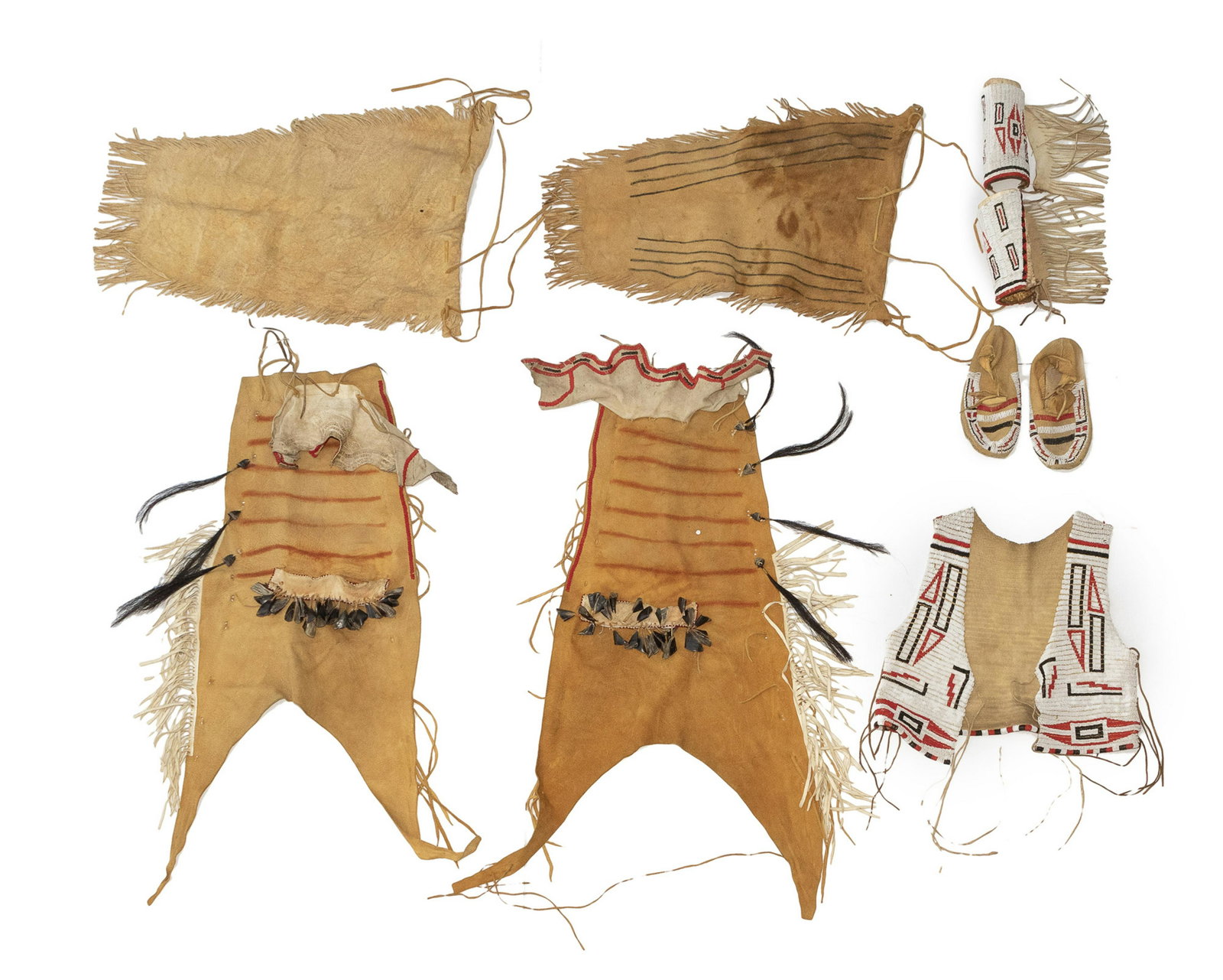 A Plains man's beaded hide outfit: Mid-20th century Comprising moccasins with matching leggings, a vest, and beaded and fringed leggings adorned with horsehair and elk's teeth, 9 pieces Vest: 19" H x 17.5" W Provenance: Property of a P