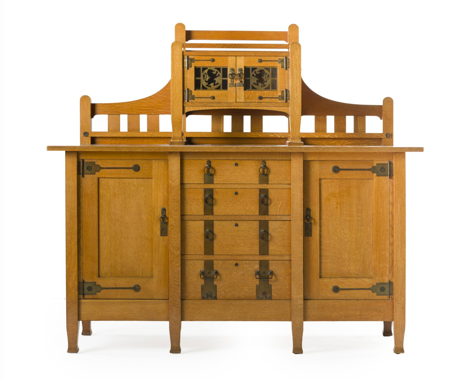 An oak Arts & Crafts Quaint sideboard, No. 8604: First quarter 20th century Design attributed to David Robertson Smith, the slatted gallery over a glazed cabinet with copper overlay lion rampant overlaid doors over a cabinet fitted with four short d