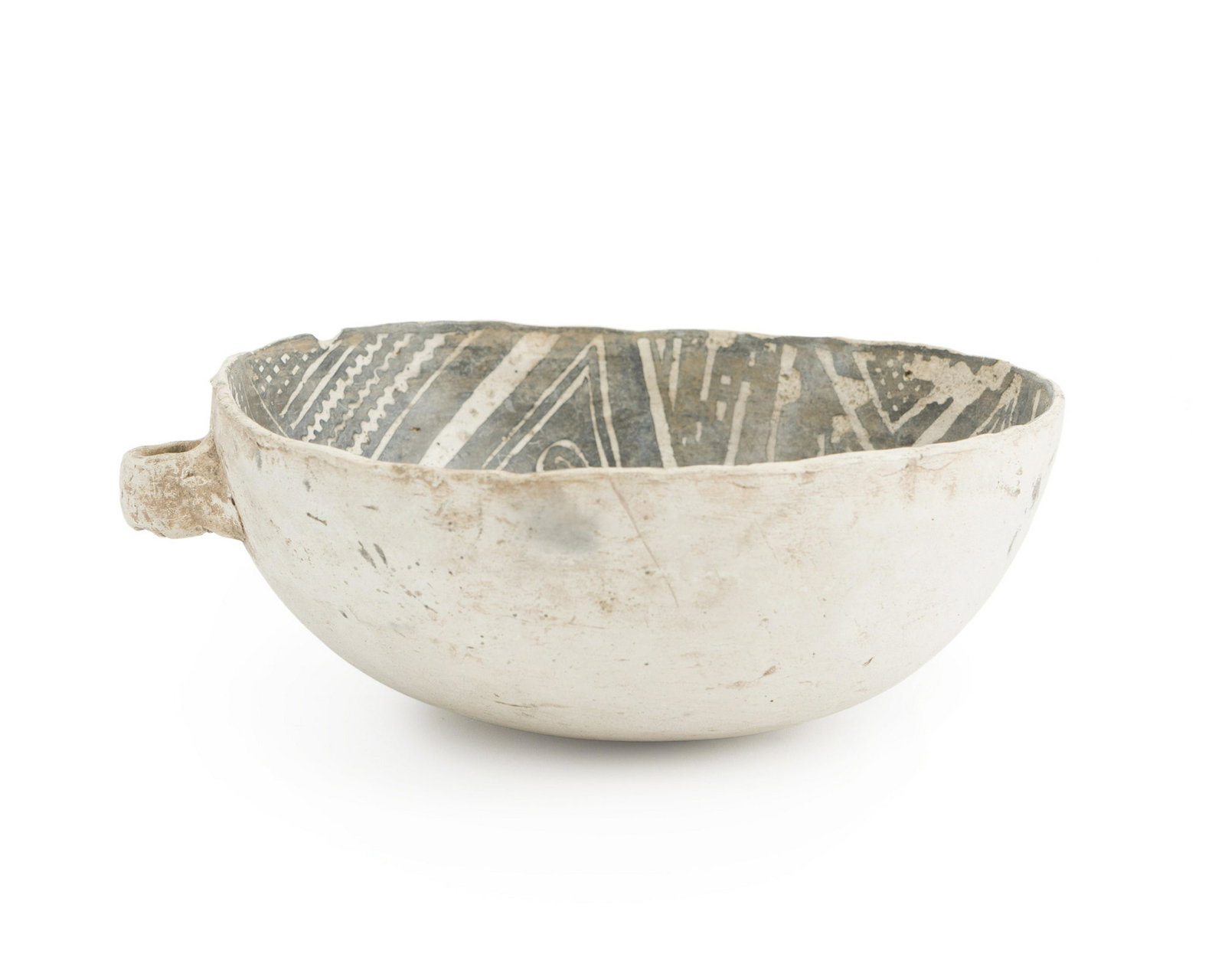 An Anasazi pottery bowl: Pre-historic Hand coiled and pit fired with black on white geometric interior motif and lug handles 3.5" H x 9.5" W, 8.75" Dia.