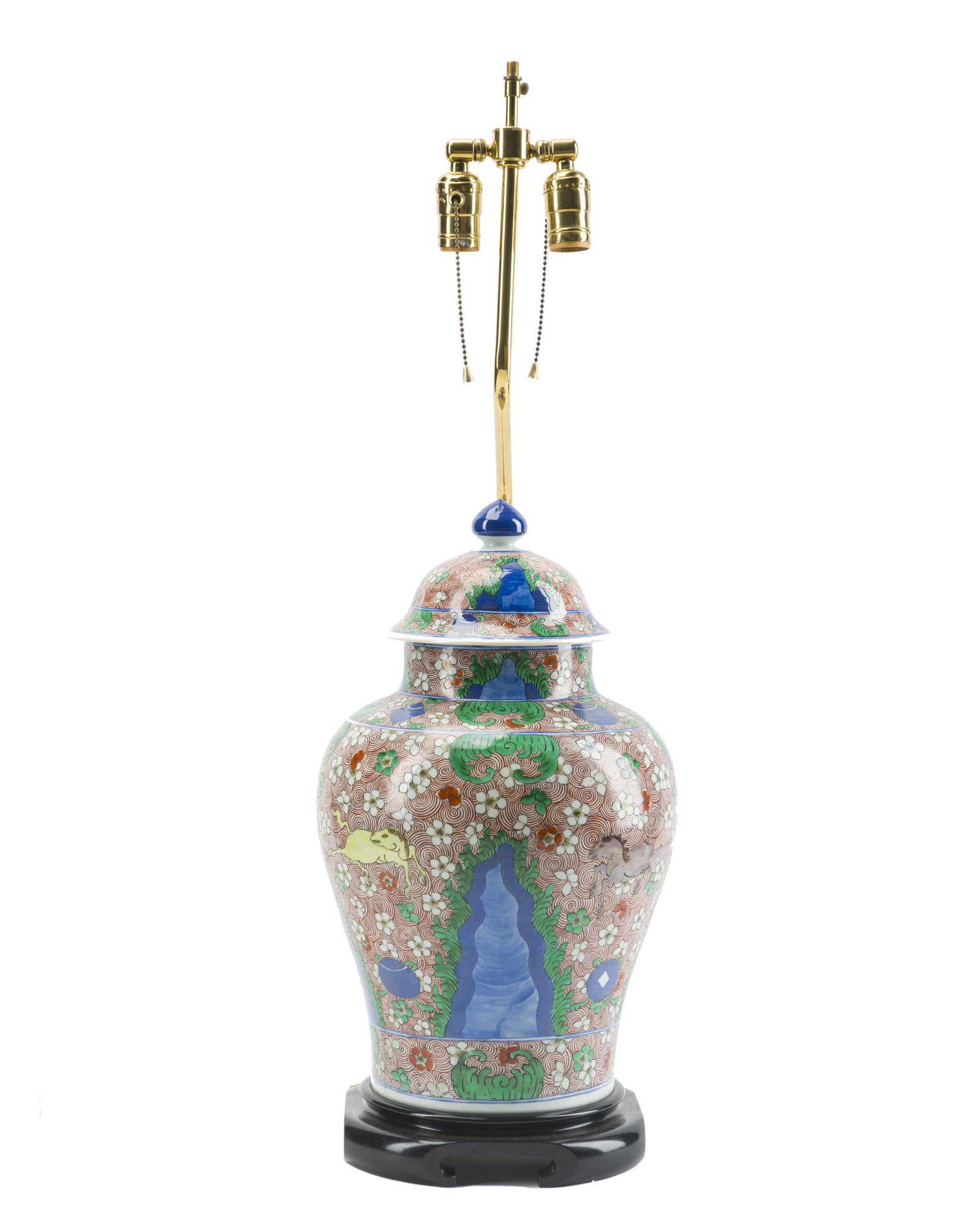 A Chinese ginger jar table lamp: 20th century The ceramic jar all-over decorated with natural and mythic motifs mounted to a wood plinth with offset two-light brass lamp, lacking shade and finial Jar: 17" H x 9.5" Dia.; Overall: 31.5