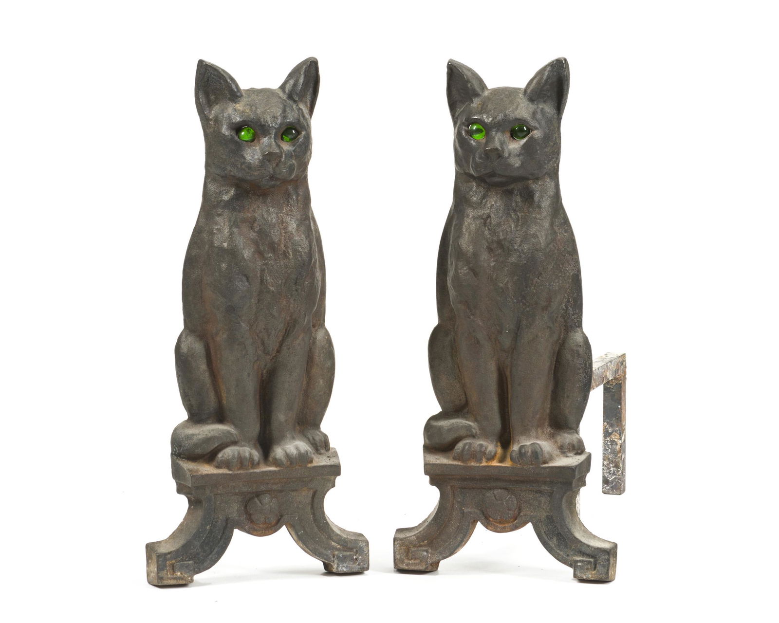 A pair of cat-motif andirons: First half 20th century Each cat-form andiron with glass eyes set into a cast iron base, 2 pieces Each: 17" H x 15.75" W x 7.325" D