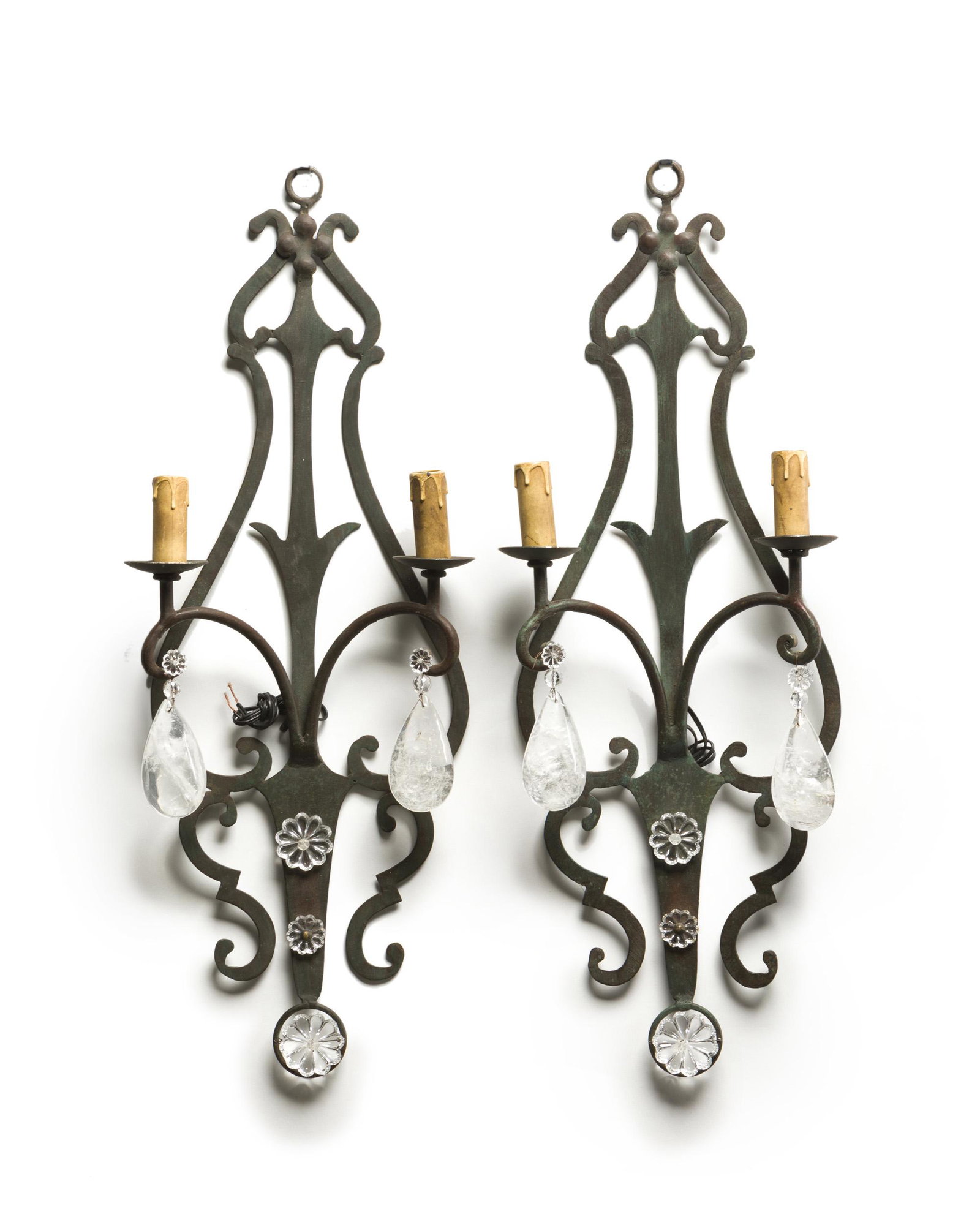 A pair of rock crystal and wrought iron wall sconces: 20th century Each two-light sconce in a wrought iron frame adorned with plastic flower elements and rock crystal drops, 2 pieces Each: 27.125" H x 9.25" W x 3.5" D