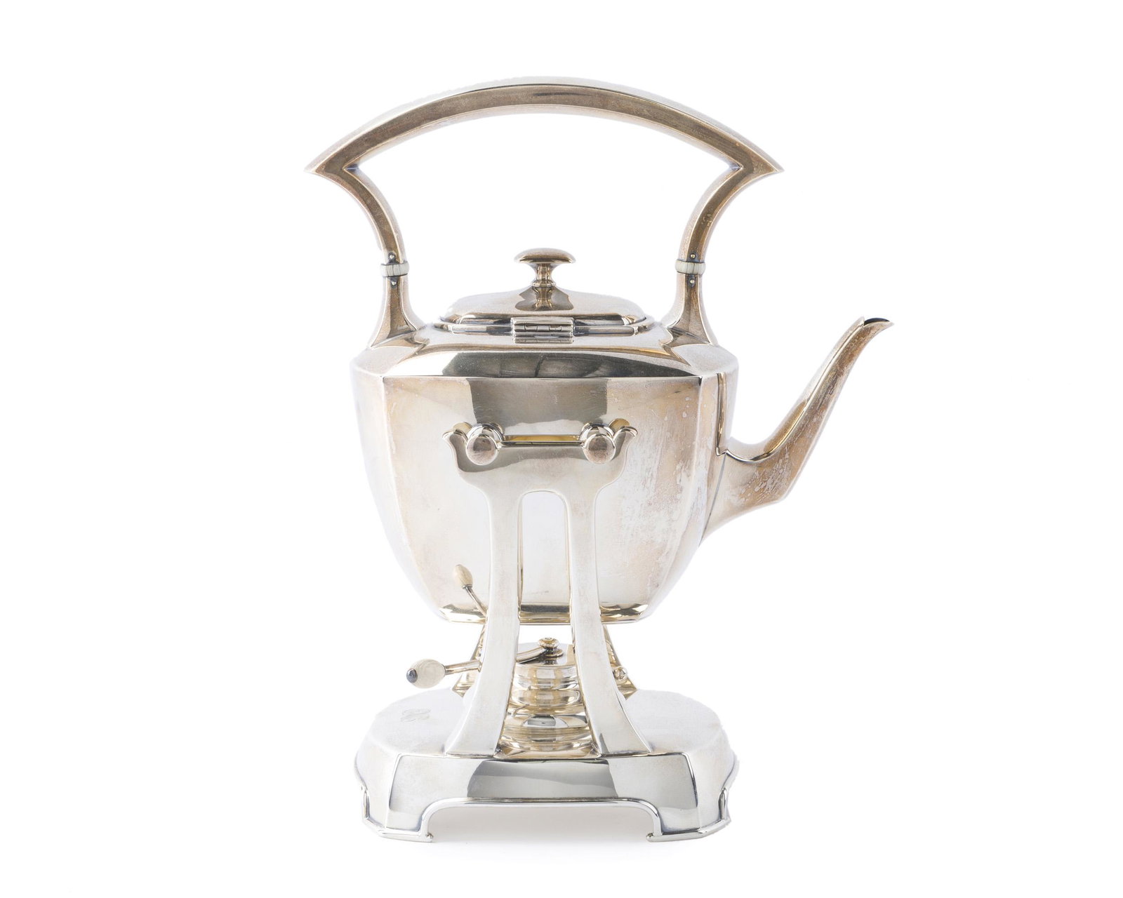 A J.E. Caldwell sterling silver tipping kettle: Second quarter 20th century Stamped: J.E. Caldwell & Co. / Sterling / 9166 The curved handle over a rounded rectangular body raised over a base fitted with a burner, monogrammed: ENC 11.75" H x 9.