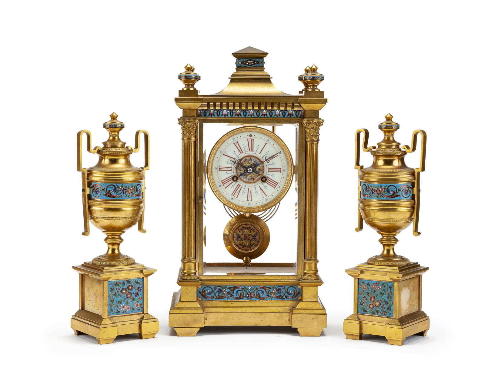 A French bronze champlevé crystal regulator: Late 19th/early 20th century Movement numbered: 2309 Surmounted by a stepped pediment, the rectangular glazed case centering a glazed door flanked by Corinthian columns and enclosing a white enamel cl