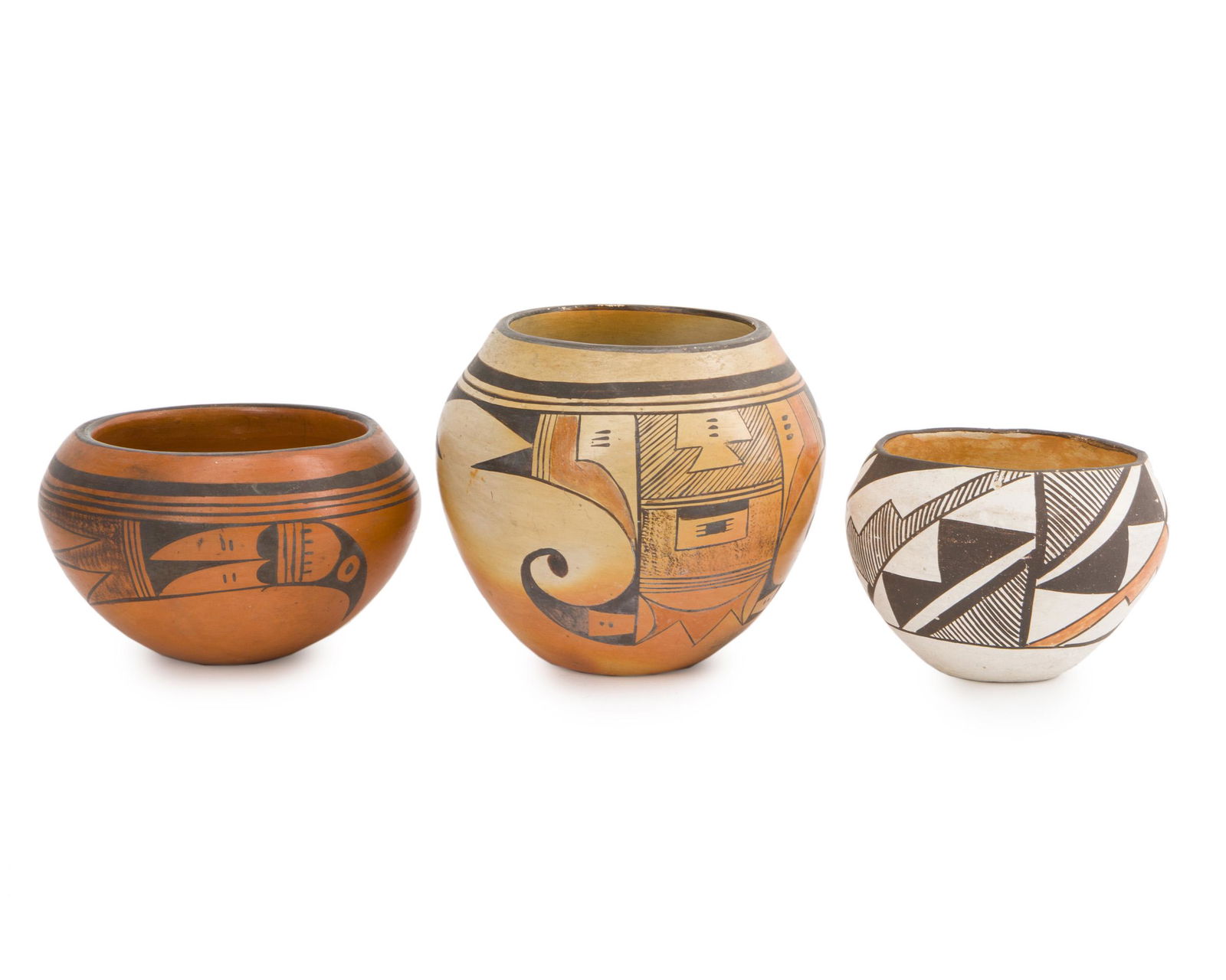 Three Acoma pots: Second half 20th century The first: Corncob artist's device Comprising one redware avian-motif pot, one geometric pot, and one small geometric pot, 3 pieces Largest: 5" H x 5.5" Dia.