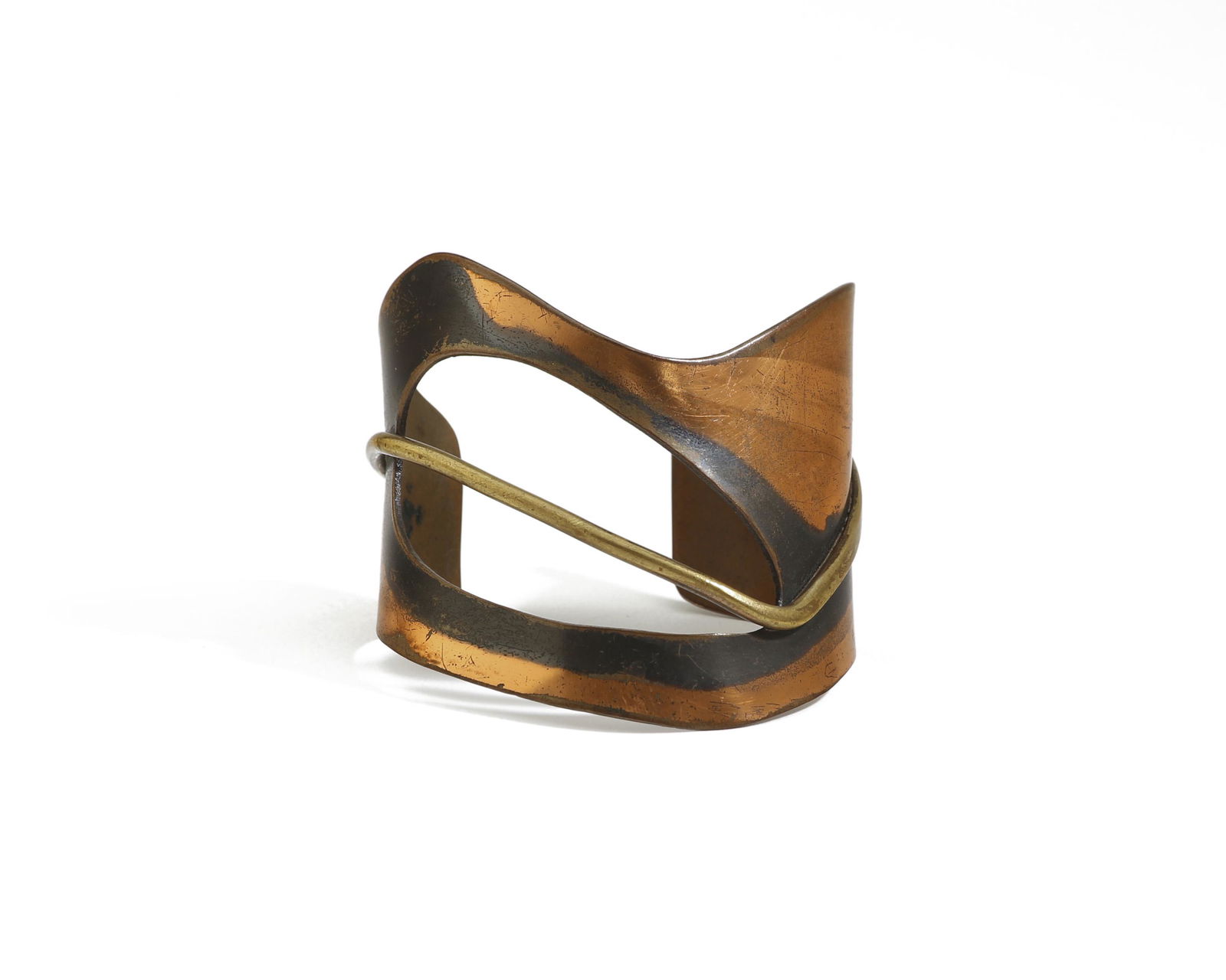 An Art Smith Modernist copper and brass cuff: Third quarter 20th century Signed: Art Smith The copper cuff adorned with a brass embellishment 2.5" H x 6.5" C; Wrist opening: 1.125" Provenance: The Collection of Cindy Tietze-Ho