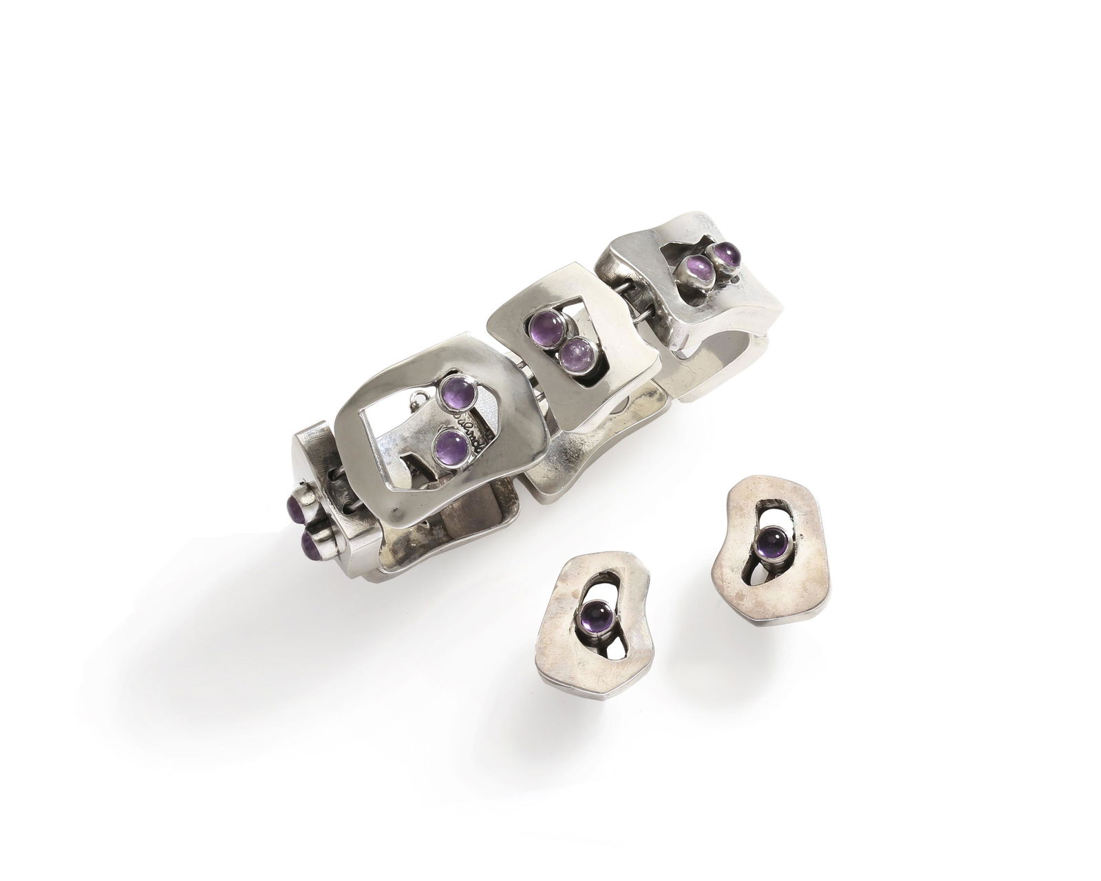 A set of Salvador Terán silver jewelry: Circa 1950s Stamped: Salvador / Taxco / Mexico; Eagle 36 Comprising a silver bracelet with amethyst cabochons together with a pair of matching screw-back earrings, 3 pieces Bracelet: .875" H x