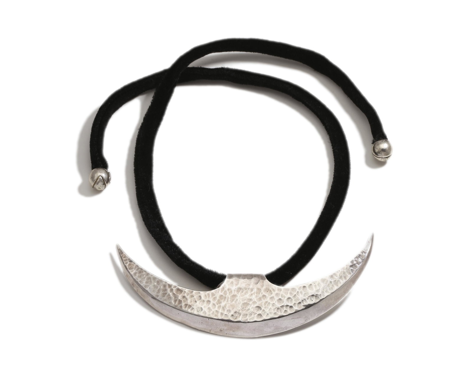 An Antonio Pineda hammered silver pendant: Post-1953 Crown mark for Antonio Pineda; Partially rubbed Eagle; Further stamped: Hecho en Mexico / Silver / YY 604 Large silver hammered necklace in crescent shape on black velvet cord with round tip