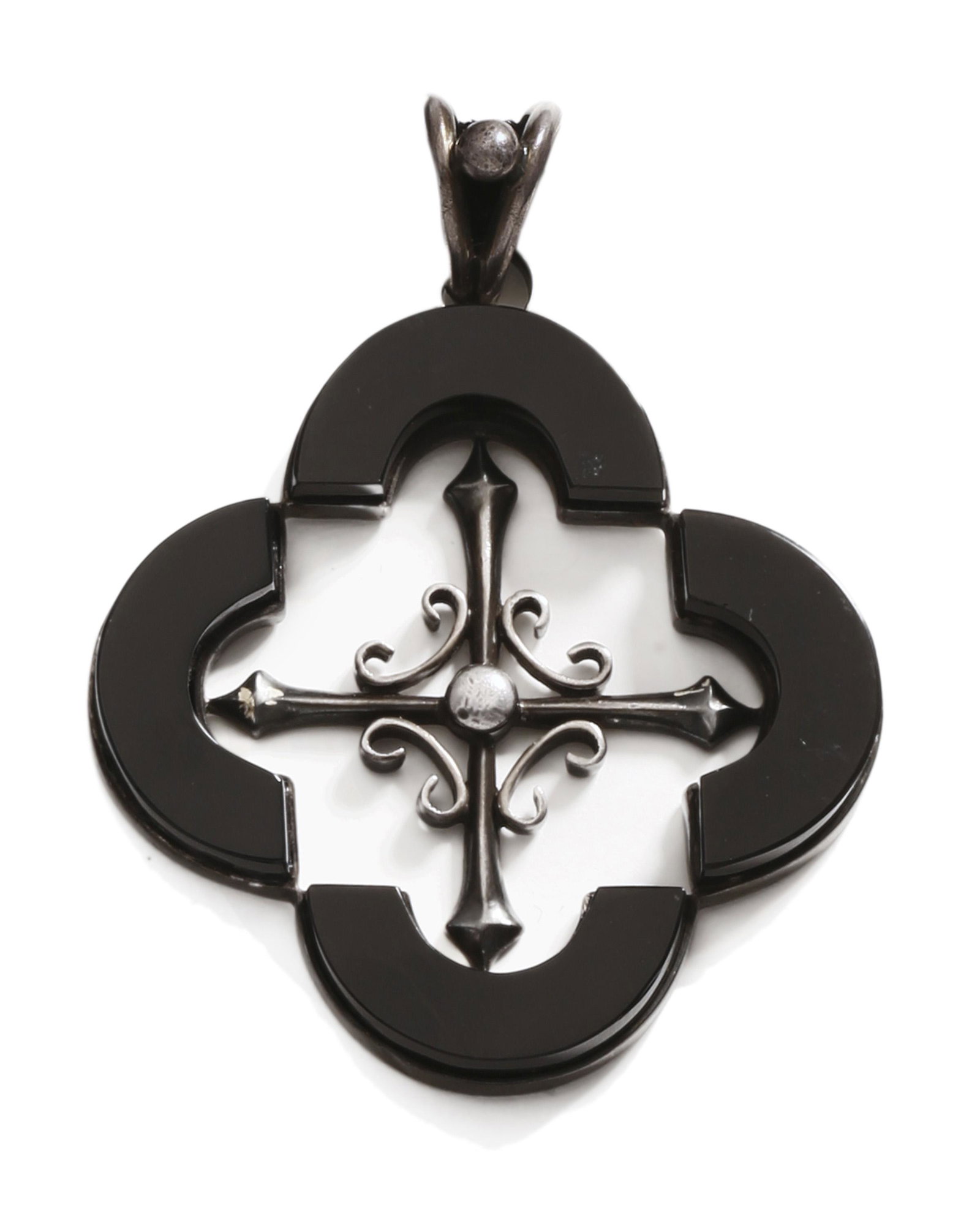 An Antonio Pineda silver and onyx quatrefoil necklace: Post-1953 Crown mark for Antonio Pineda; Eagle 17; Further stamped: Hecho en Mexico / 970 / Sterling / Silver / YY634 The quatrefoil necklace with silver and onyx layered pendant on black velvet cord 