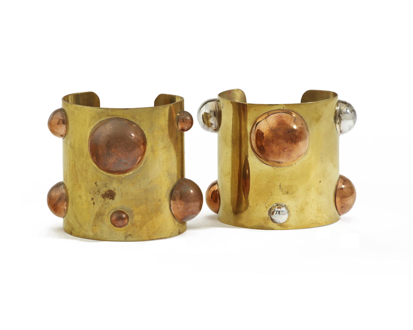 Two Hubert Harmon mixed metal cuffs: Circa 1940s Each stamped: Hubert Harmon Mexico Comprising two brass cuffs with applied bubbles, one with copper and one with copper and brass, 2 pieces Each approximately: 2.75" H x 7.5"