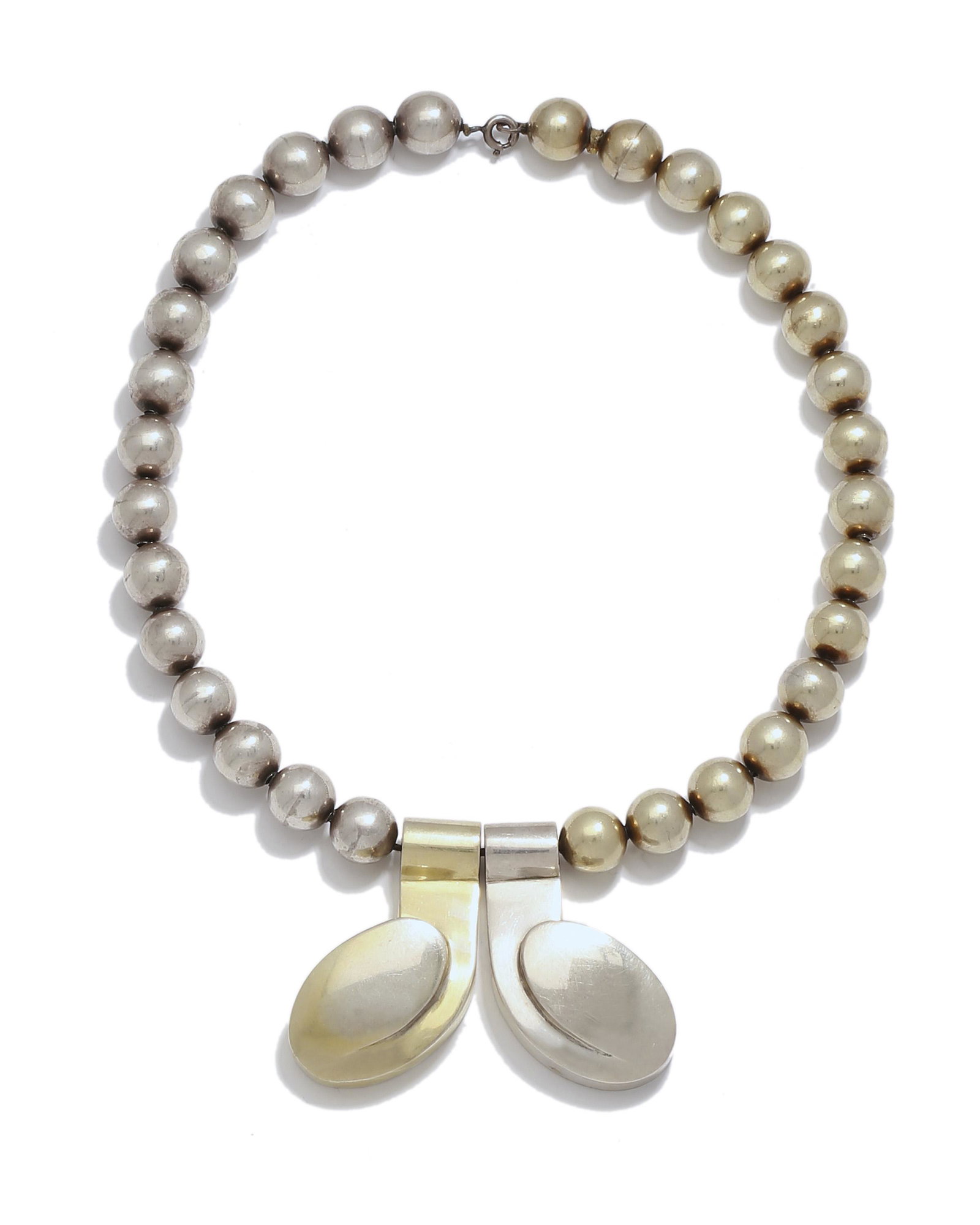 A William Spratling "Lenguas" sterling and: 1951-1956, Third Design Period Stamped for William Spratling; Further stamped: 925 The sterling silver and vermeil ball-motif neckchain suspending two stylized tongues Pendant: 1.875" H x 2.25&qu
