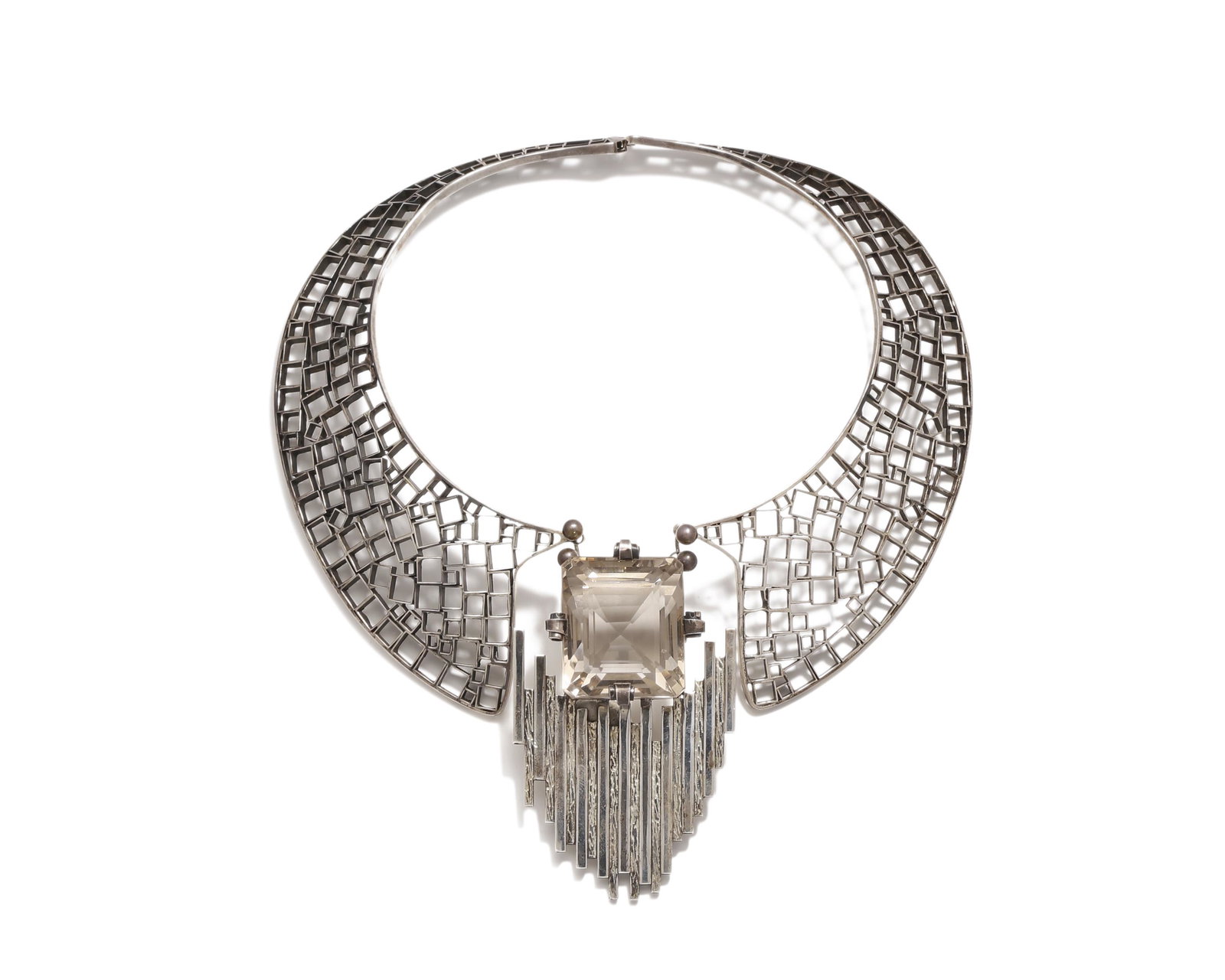 An Aaron Rubenstein Modernist sterling silver necklace: 1986 Signed: Aaron Rubenstein / Jan. 5 1986 / Sterling w/ smokey topaz The Peter Pan-collared necklace suspending a large faceted smokey topaz from a matchstick-motif pendant Pendant: 3.75" H x 2
