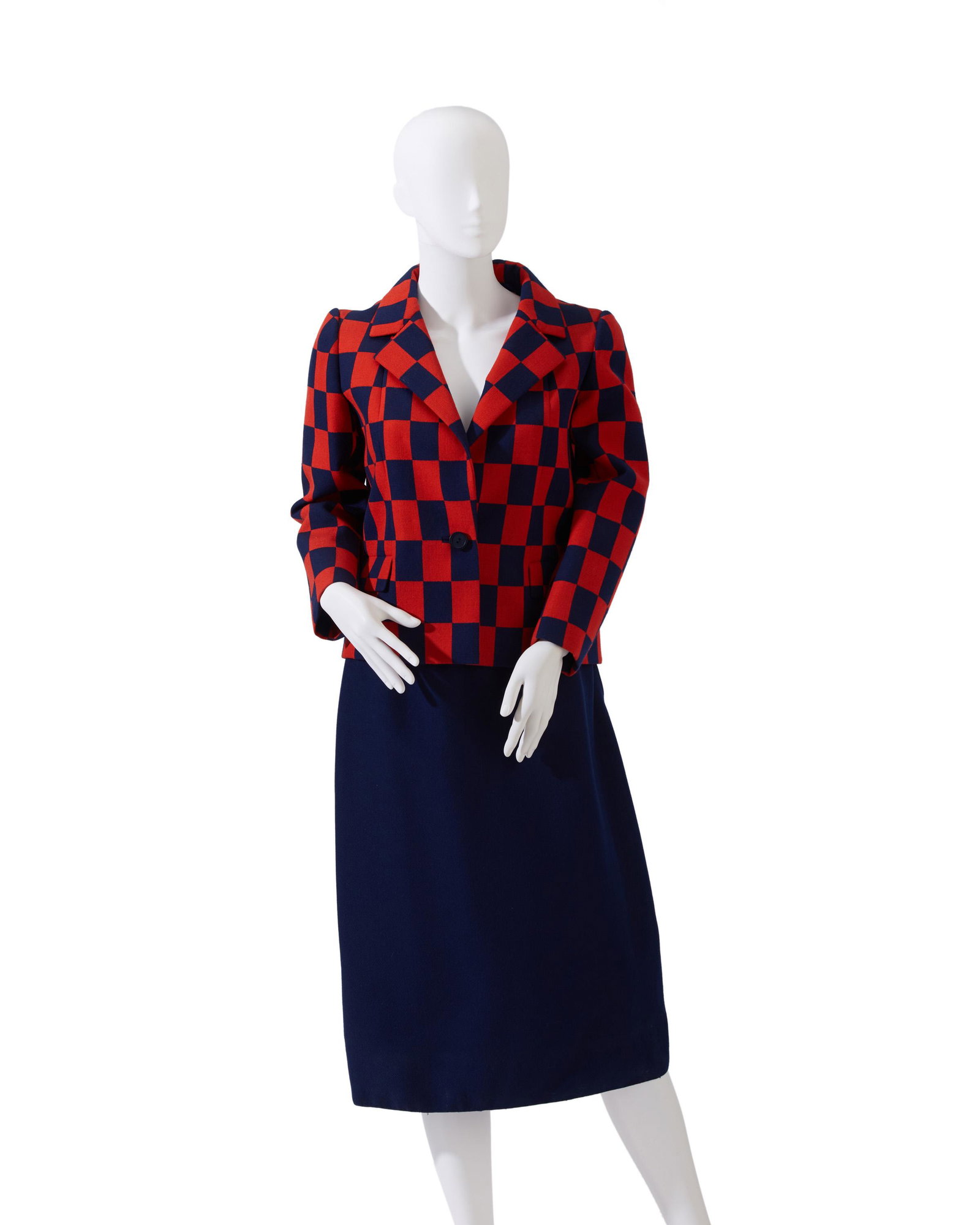 A Norman Norell skirt suit: Circa 1960s Fabric label: Norman Norell Navy and red jacket with skirt, 2 pieces Jacket: Shoulder to shoulder 16.25; Bust 19.5; Seam of collar to hem: 22.5"; Skirt, waist: 13.75"; Length: 28