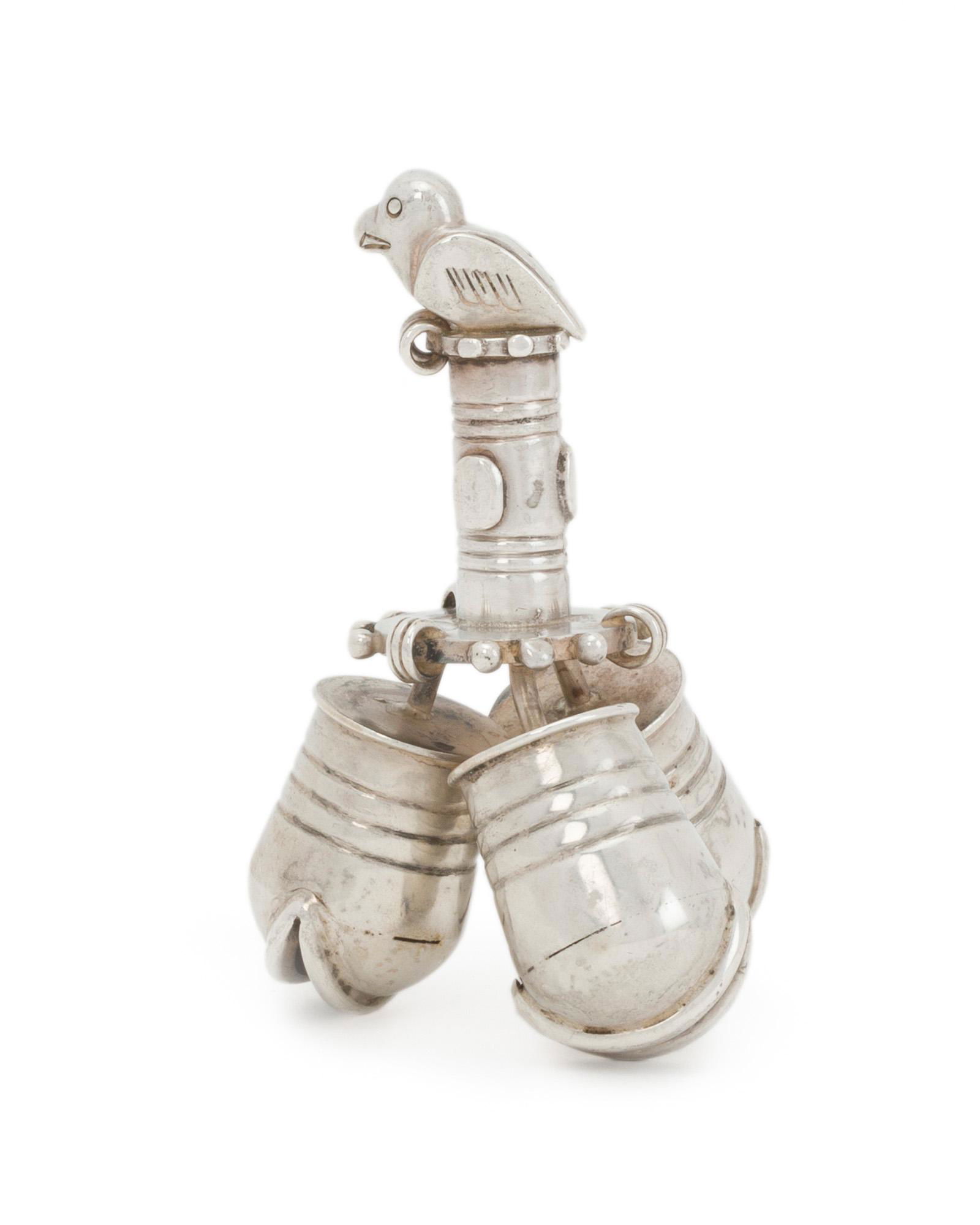 A William Spratling silver dinner bell: 1931-1946; First Design Period; Taxco, Mexico Stamped for William Spratling; Further stamped: Made in Mexico / Spratling Silver Designed with three ribbed bells surmounted by a bird-topped handle 3