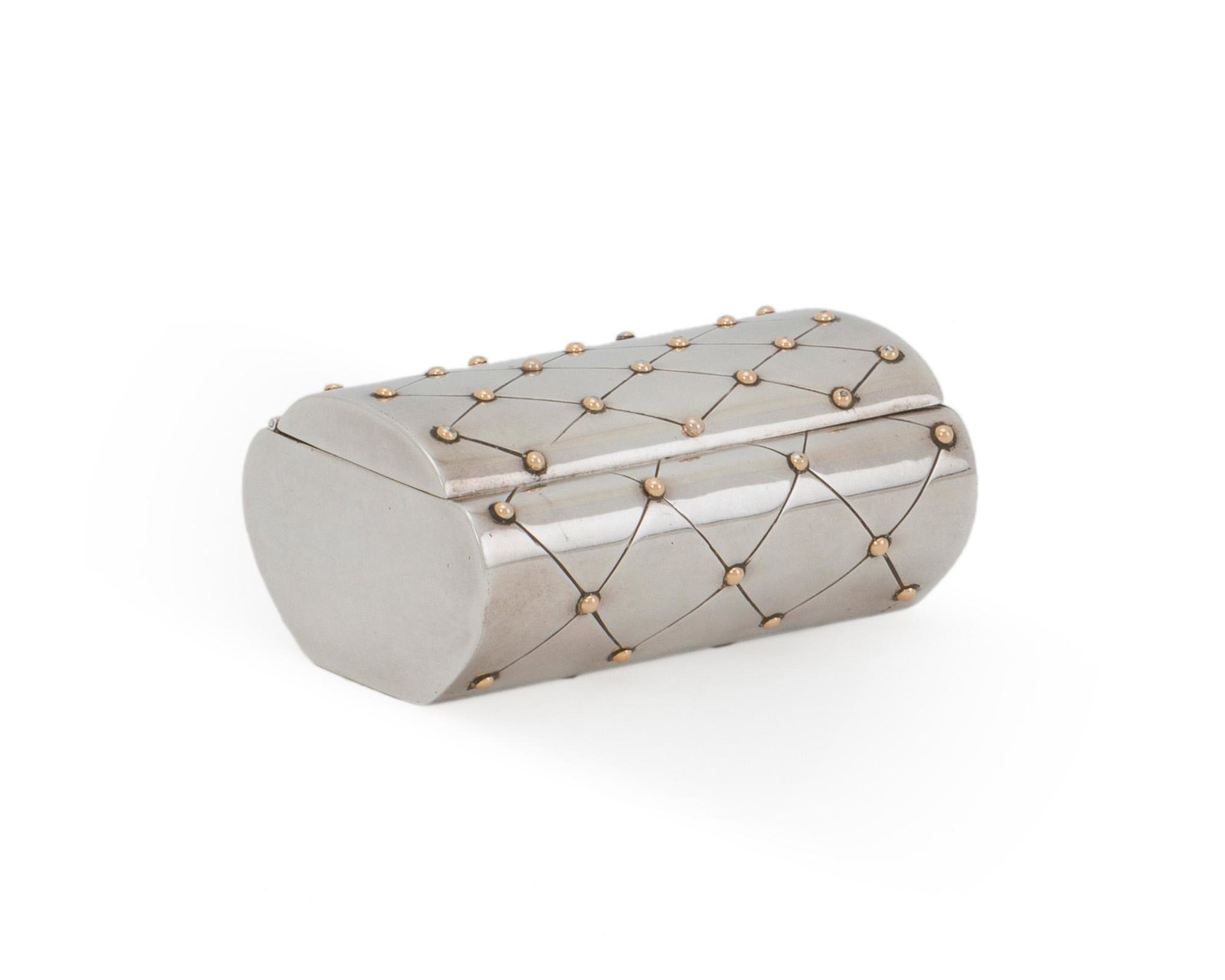 A William Spratling silver and vermeil vanity box: 1956-1962; Third Design Period; Taxco, Mexico Stamped for William Spratling; Further stamped: Eagle 30 / 925 The quilted hinged top with vermeil studs enclosing a single compartment 1.75" H x 3.625" W