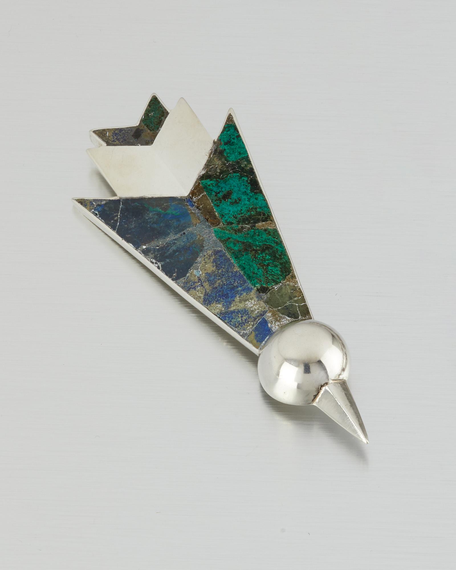 A William Spratling sterling silver and azurmalachite: 1950-1967; Third Design Period; Taxco, Mexico Stamped for William Spratling; Further stamped: 925 The stylized hummingbird set with inlaid azurmalachite panels 4.625" H x 1.75" W 47.5 grams Provenance