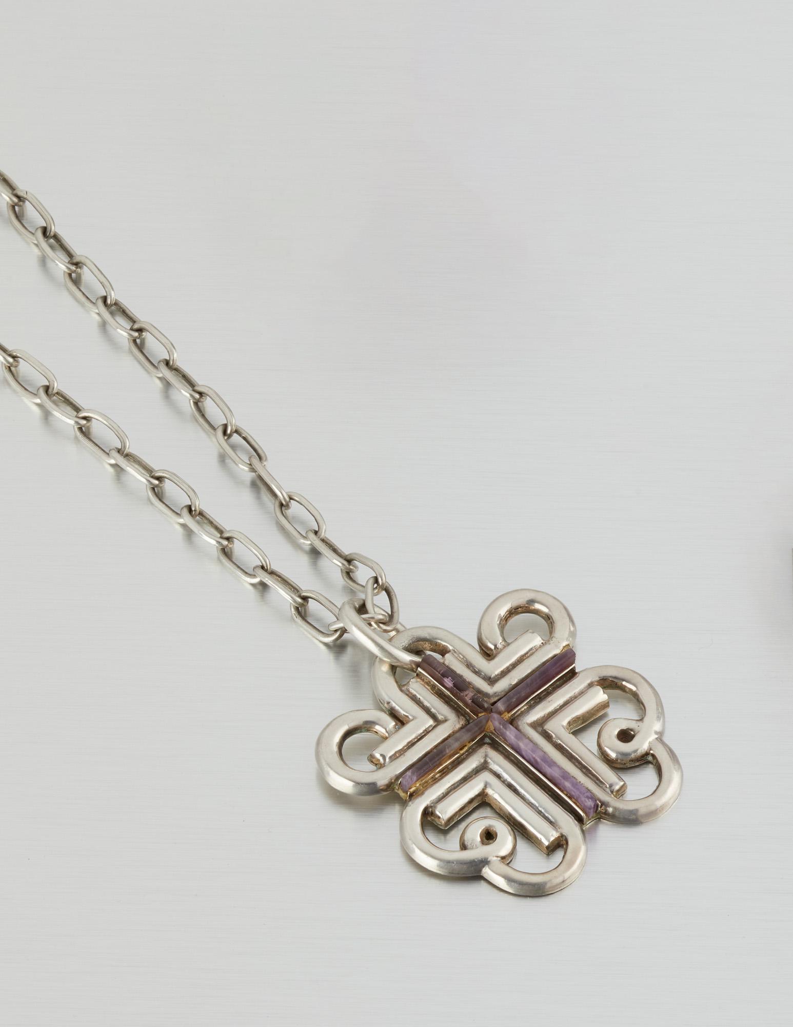 A William Spratling silver and amethyst pendant and: 1949-1956 and 1964-1967; Third Design Period; Taxco, Mexico Each Stamped for William Spratling; Further stamped: 925/ Taxco Mexico / Eagle 30 The stylized cross inset with carved amethyst suspended on