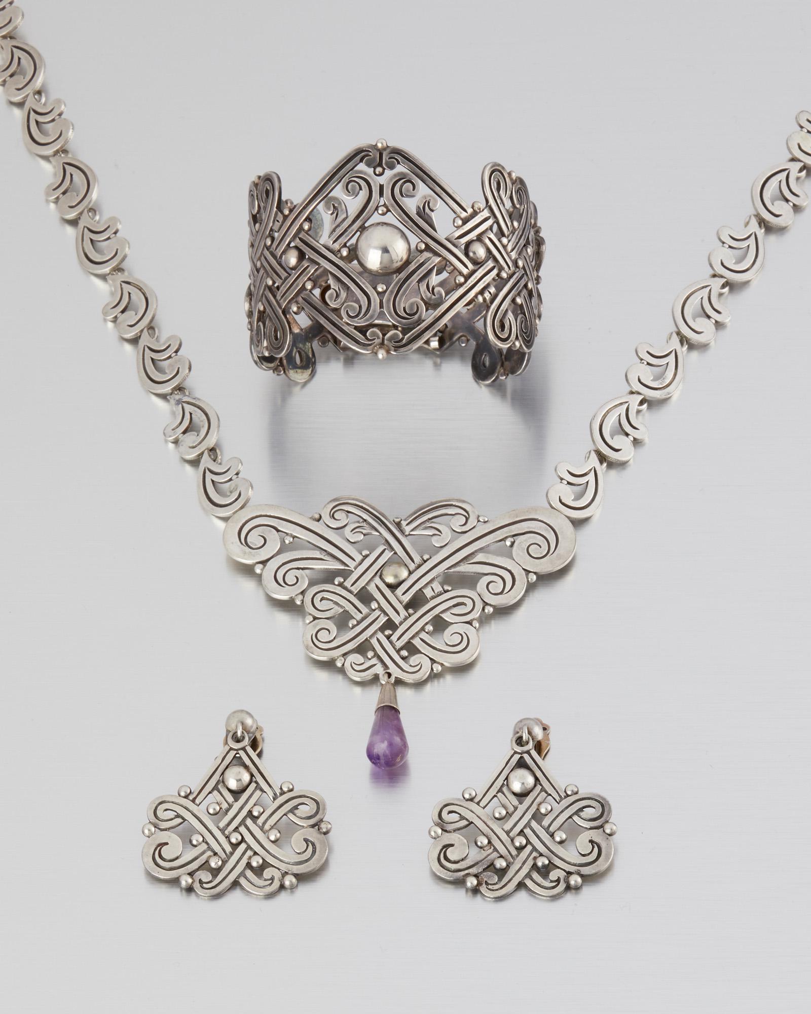 A suite of Los Castillo silver and amethyst jewelry: 1948-1960; Taxco, Mexico Stamped: Los Castillo; Eagle 15; Further stamped: Taxco / 359 / Indistinct hallmarks / 5108; Earrings attributed to Los Castillo Comprising a bib necklace suspending an amethy