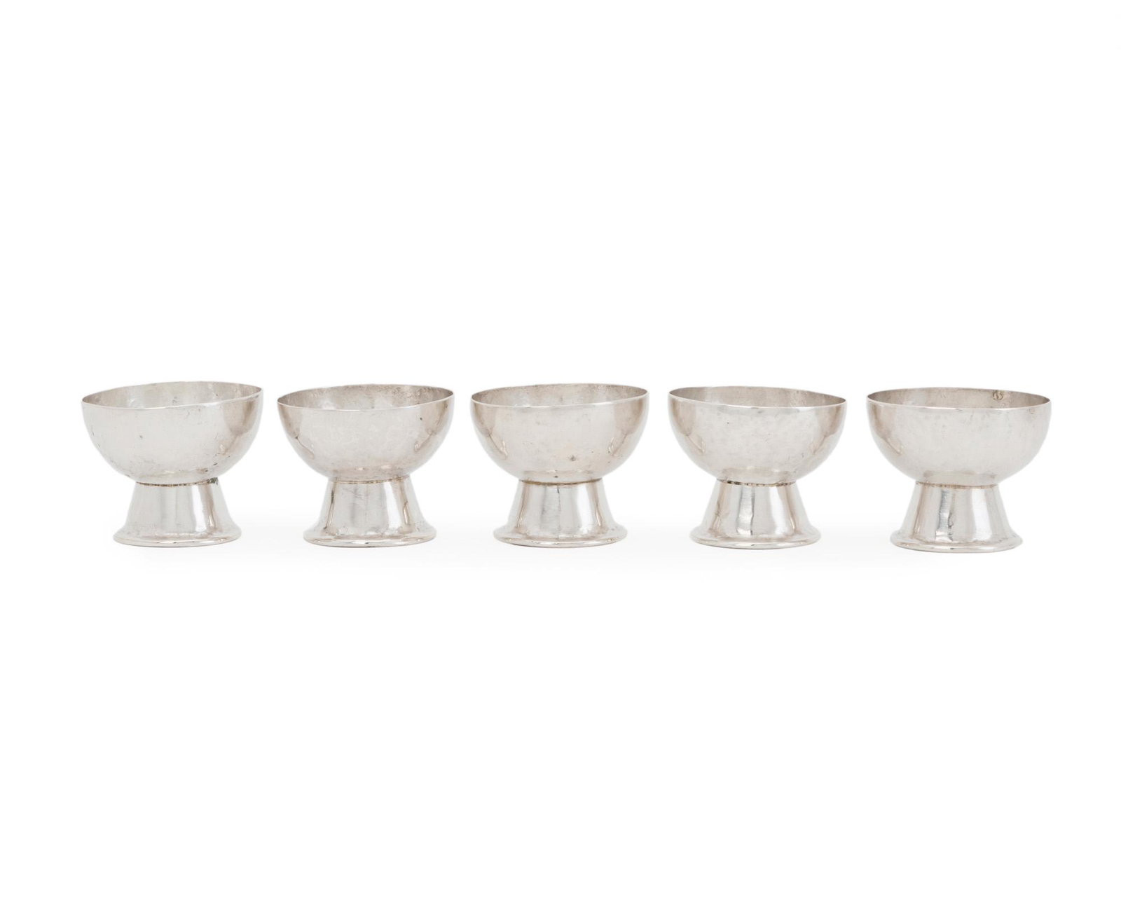 Five William Spratling silver bowls: 1933-1938; First Design Period; Taxco, Mexico Each stamped for William Spratling; Further stamped: 980 / Taxco / Mexico Each shallow bowl on a widening silver base, 5 pieces Each approximately: 2.25" 