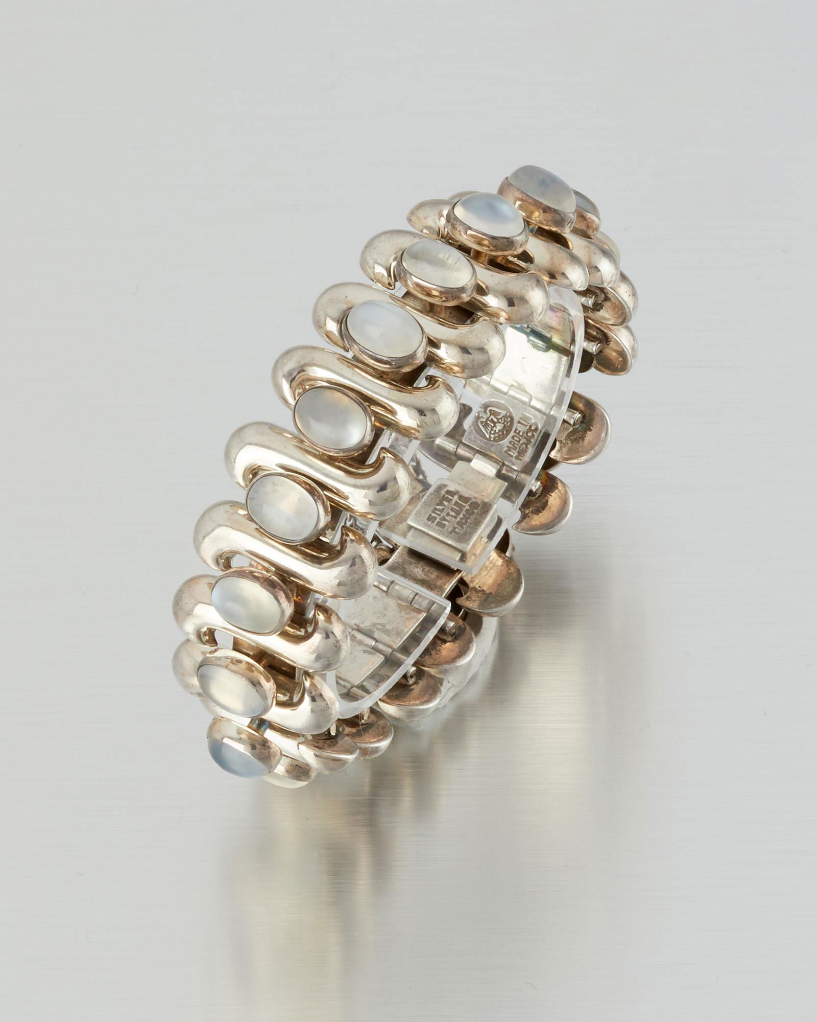 An Antonio Pineda silver and moonstone bracelet: 1948-1953; Taxco, Mexico Stamped: Silver by Tono; Eagle 17; Further stamped: Made in Mexico / Taxco Designed with undulating links alternating with oval moonstone cabochons 6.5" L x 1" H 92.0 gram