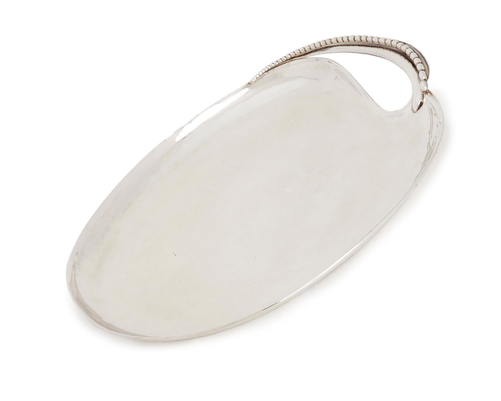An Antonio Pineda silver handled tray: 1953-1979; Taxco, Mexico Crown mark for Antonio Pineda; Eagle 17; Further stamped: Hecho en Mexico / 930 The oval tray issuing a leaf-like handle with elongated beaded detail 1.75" H x 16.125" W x 12.