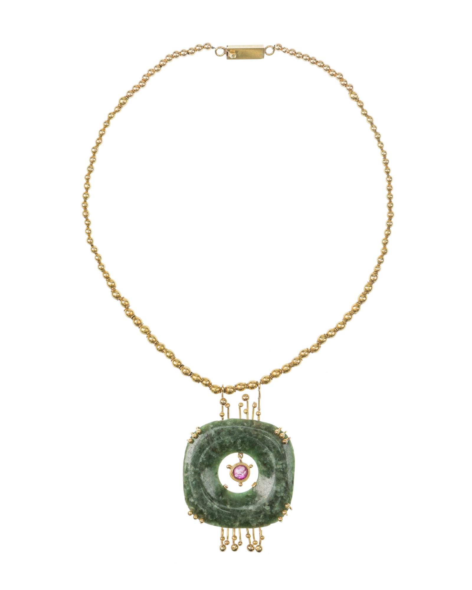 A William Spratling 18k gold gem-set necklace: 1956-1967; Third Design Period; Taxco, Mexico Stamped for William Spratling; Further stamped: 18k Centering a Pre-Columbian shaped square green stone pendant suspending a bezel-set cabochon ruby in a 