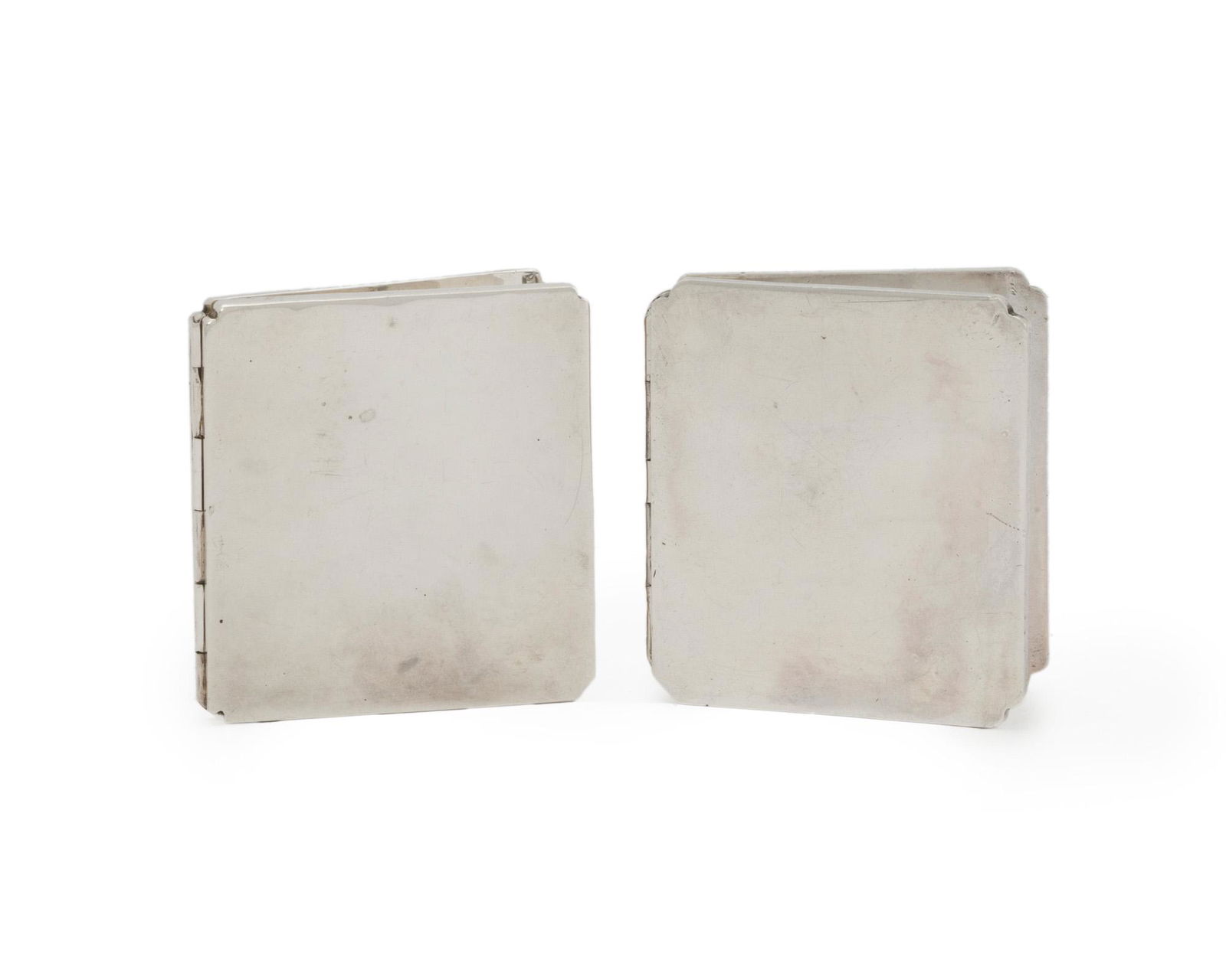 Two William Spratling silver picture frames: 1940-1946; First Design Period; Taxco, Mexico Each stamped for William Spratling; Further stamped: Spratling Silver / Made in Mexico Comprising two portable folding picture frames with clipped corne