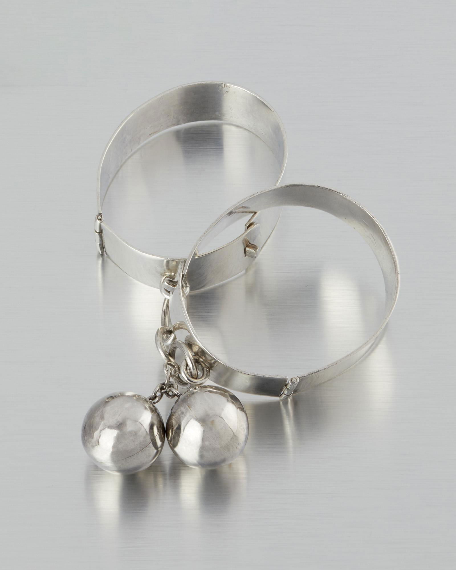 A pair of Hubert Harmon silver ball-and-chain bangle: 1944-1948; Taxco, Mexico Stamped for Hubert Harmon; Further stamped; Silver / Made in Mexico Designed as a pair of connected ball and chain hinged bangle bracelets Each approximately 7.5" C x .75"