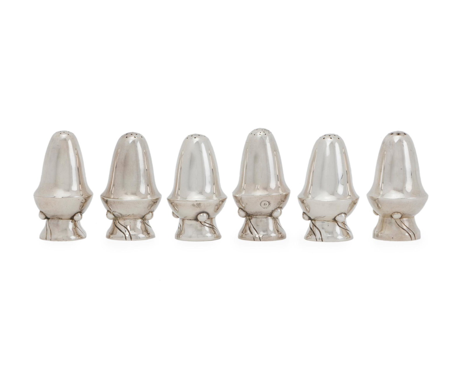 Six William Spratling sterling silver salt and pepper: 1944-1946; First Design Period; Taxco, Mexico Each stamped for William Spratling; Further stamped: Sterling Each shaker designed with an incised swirled-pattern to the base, 6 pieces Each approximatel