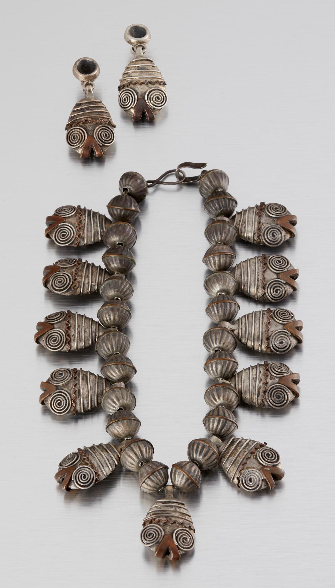 A set of Guadalupe Castellanos Mexican mixed-metal: Second quarter 20th century; Taxco, Mexico Stamped: Taxco / 980 The silver and copper bead necklace designed with ornate fish fringe with a matching pair of screw-back earrings, 3 pieces Necklace: