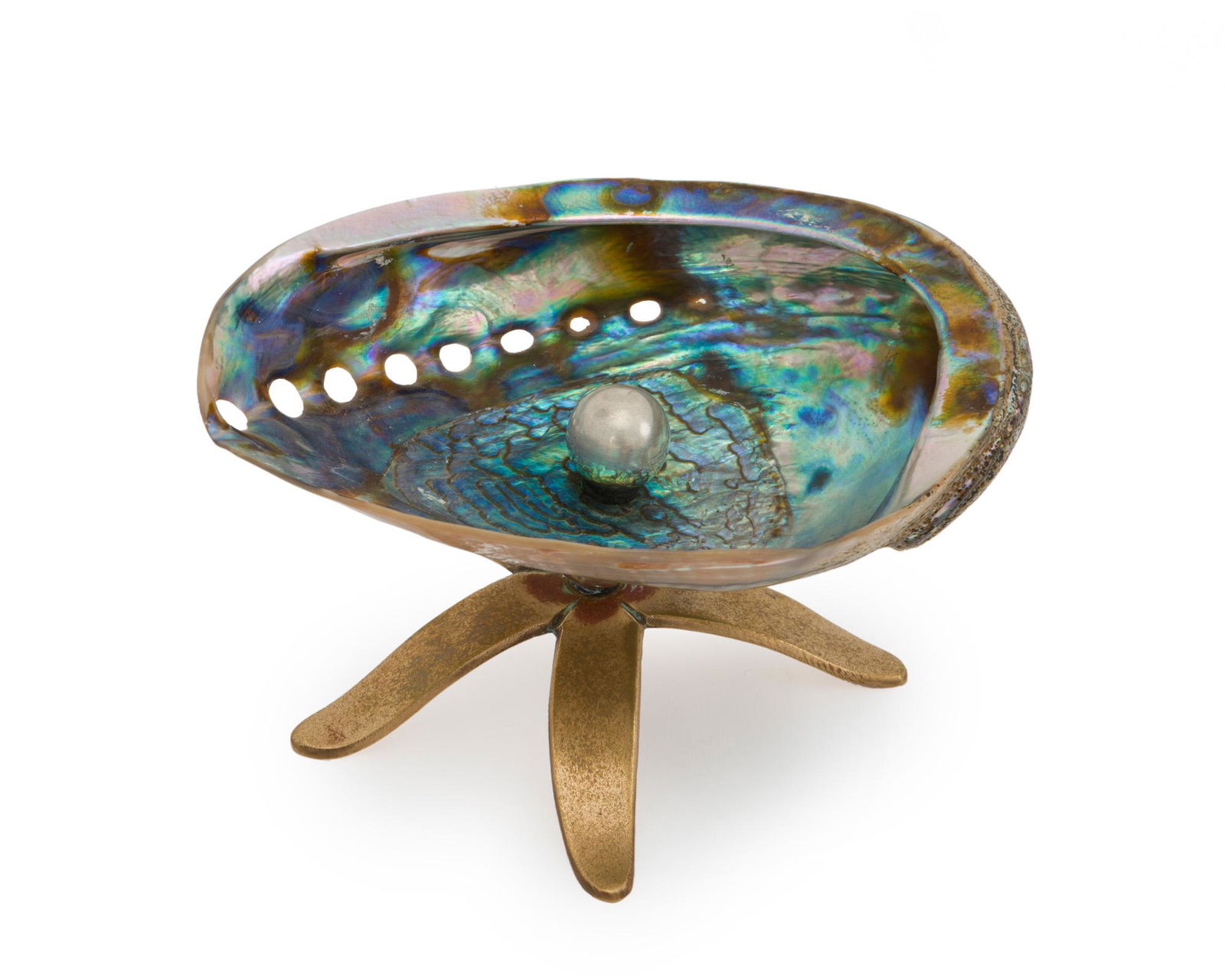 A Los Castillo abalone and mixed-metal starfish dish: Third quarter 20th century; Taxco, Mexico Stamped for Los Castillo; Further stamped: Taxco The abalone shell bowl centering an applied metal "pearl" raised on a starfish-form brass base 4" H x 6.75