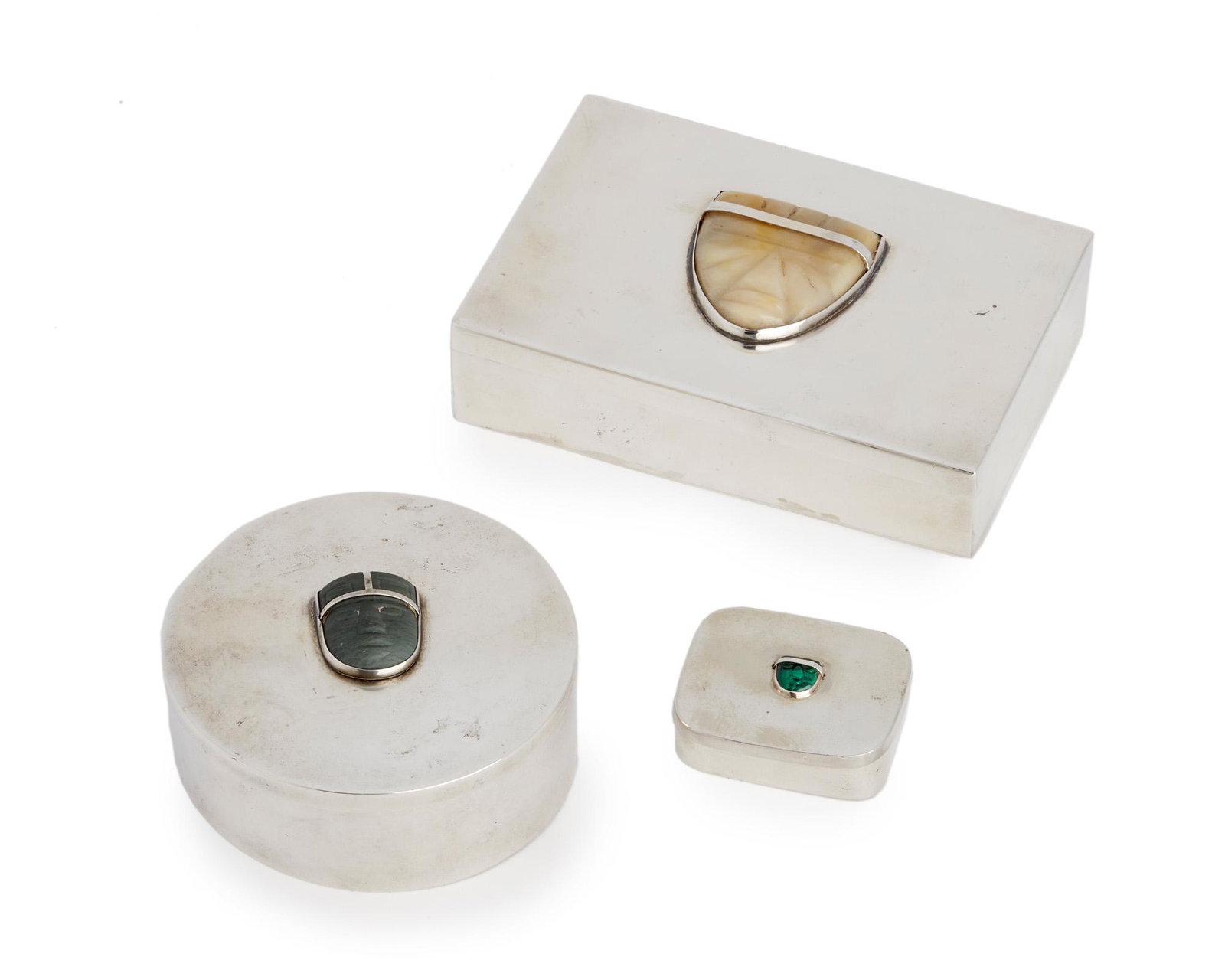 Three Fred Davis silver boxes: Second quarter 20th century; Mexico City, Mexico Each stamped for Fred Davis; Further stamped: 925 Each lidded box set with an Olmec-style carved stone or pottery head, 3 pieces Largest: 1.25" H x 5.1