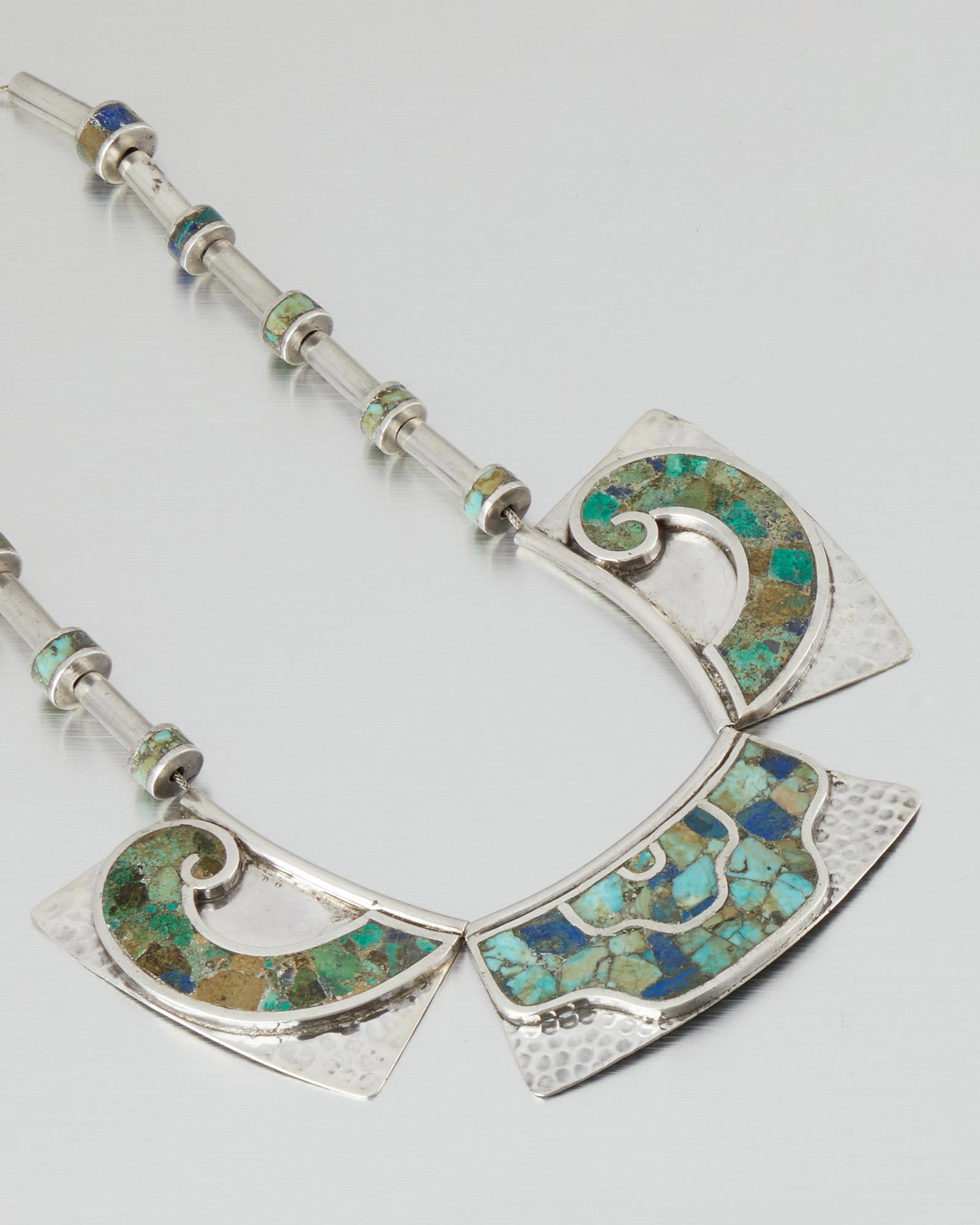 A Los Castillo silver and mosaic hardstone necklace: 1950-1965; Taxco, Mexico Stamped: Los Castillo; Eagle 1; Further stamped: Taxco / Made in Mexico / Sterling / Mosaico Azteca / 135 The triple-panel necklace designed with inlaid chrysocolla and azurma