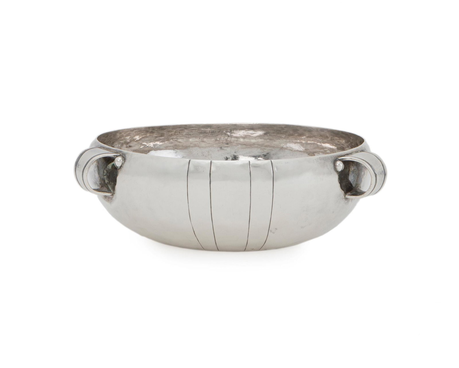 A William Spratling sterling silver handled bowl: 1933-1938; First Design Period; Taxco, Mexico Stamped for William Spratling; Further stamped: 925 / Taxco Mexico One of Spratling's earliest designs, the hammered and smooth-finish bowl with incised s