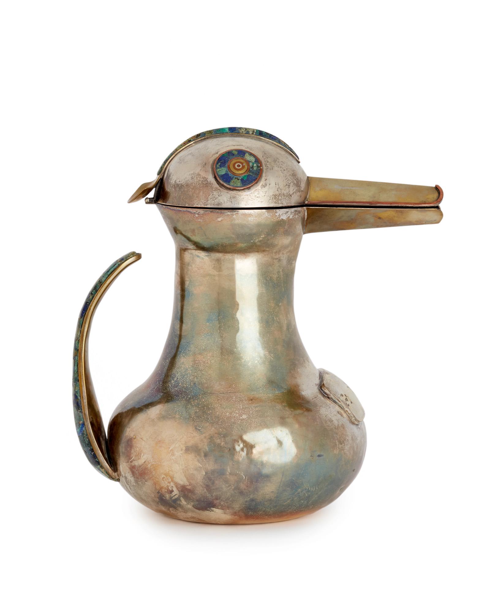 A Los Castillo silver and mixed-metal water pitcher: Third quarter 20th century; Taxco, Mexico Stamped for Los Castillo; Further stamped: Plateado In the form of a long-beaked bird with hinged lid for a head over a bulbous body issuing an inlaid tail/ha
