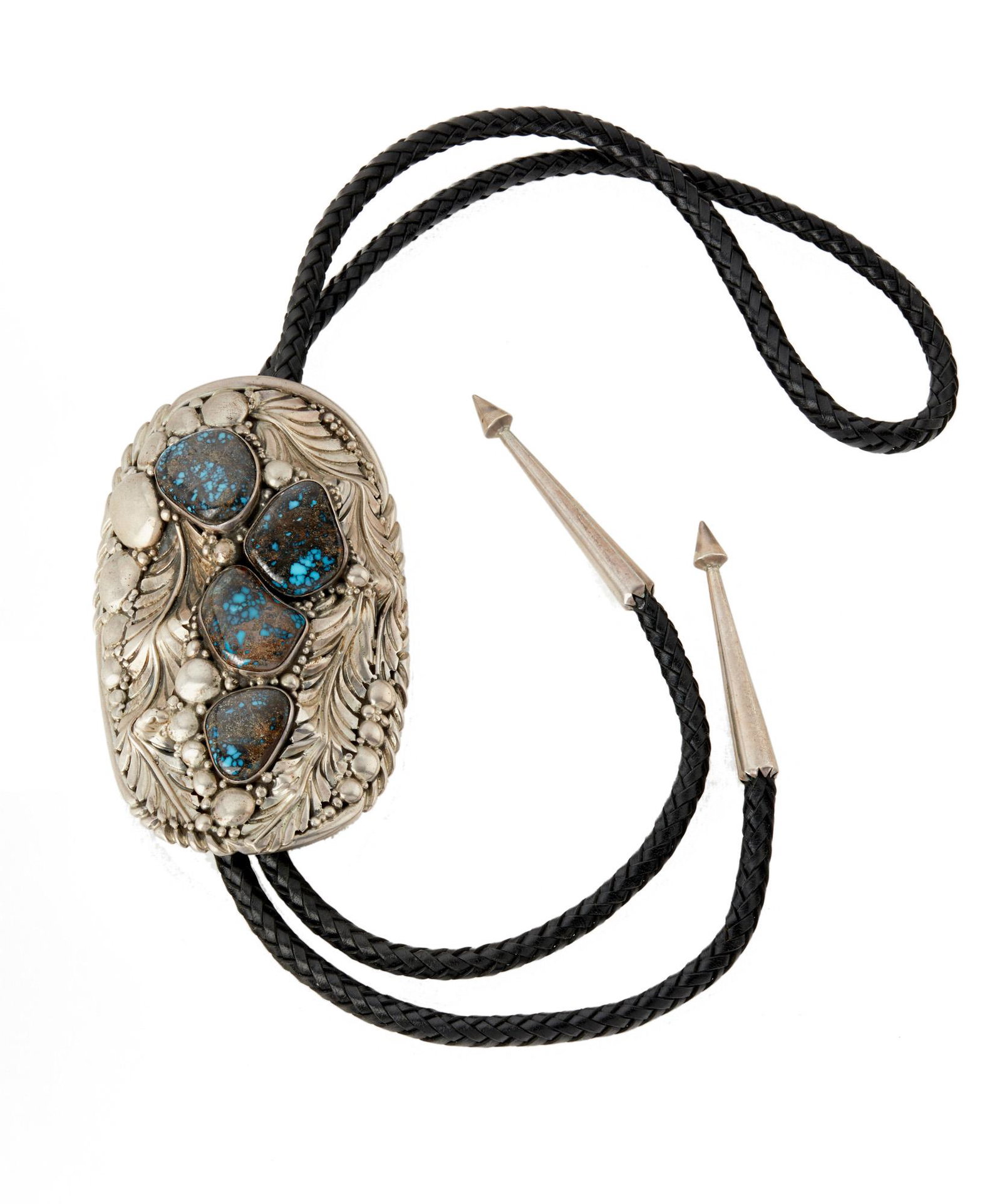 A Navajo David Zachary sterling silver and turquoise: A Navajo David Zachary sterling silver and turquoise bolo tie Stamped: David Zachary / Sterling Set with four turquoise stones in an elaborate pendant 21.25" H; Pendant: 4.325" H x 2.625" W 230.0 gram