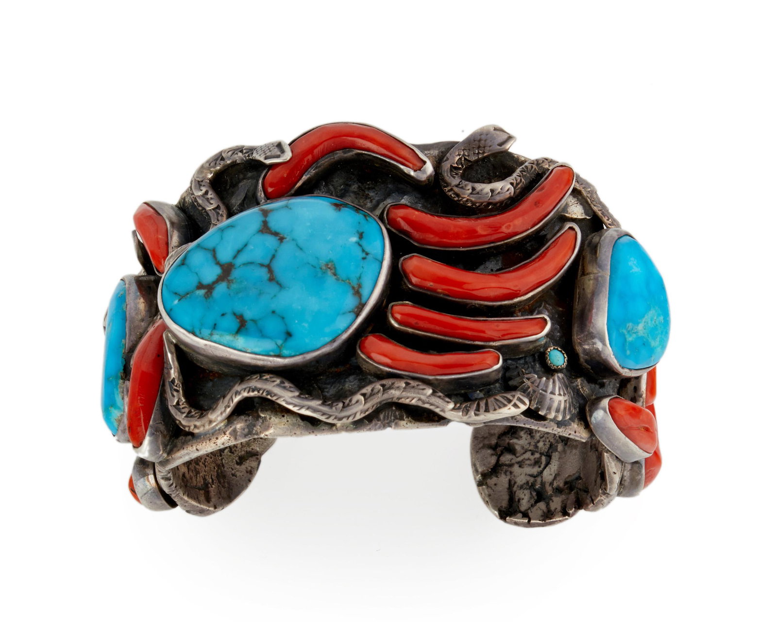 A Southwest coral and turquoise bracelet: A Southwest coral and turquoise bracelet Stamped: RC, possibly Ronnie Calabaza Set with coral and turquoise in a bear claw and snake design 6.75" C x 1.75" H with a 1.125" wrist opening 164.0 grams