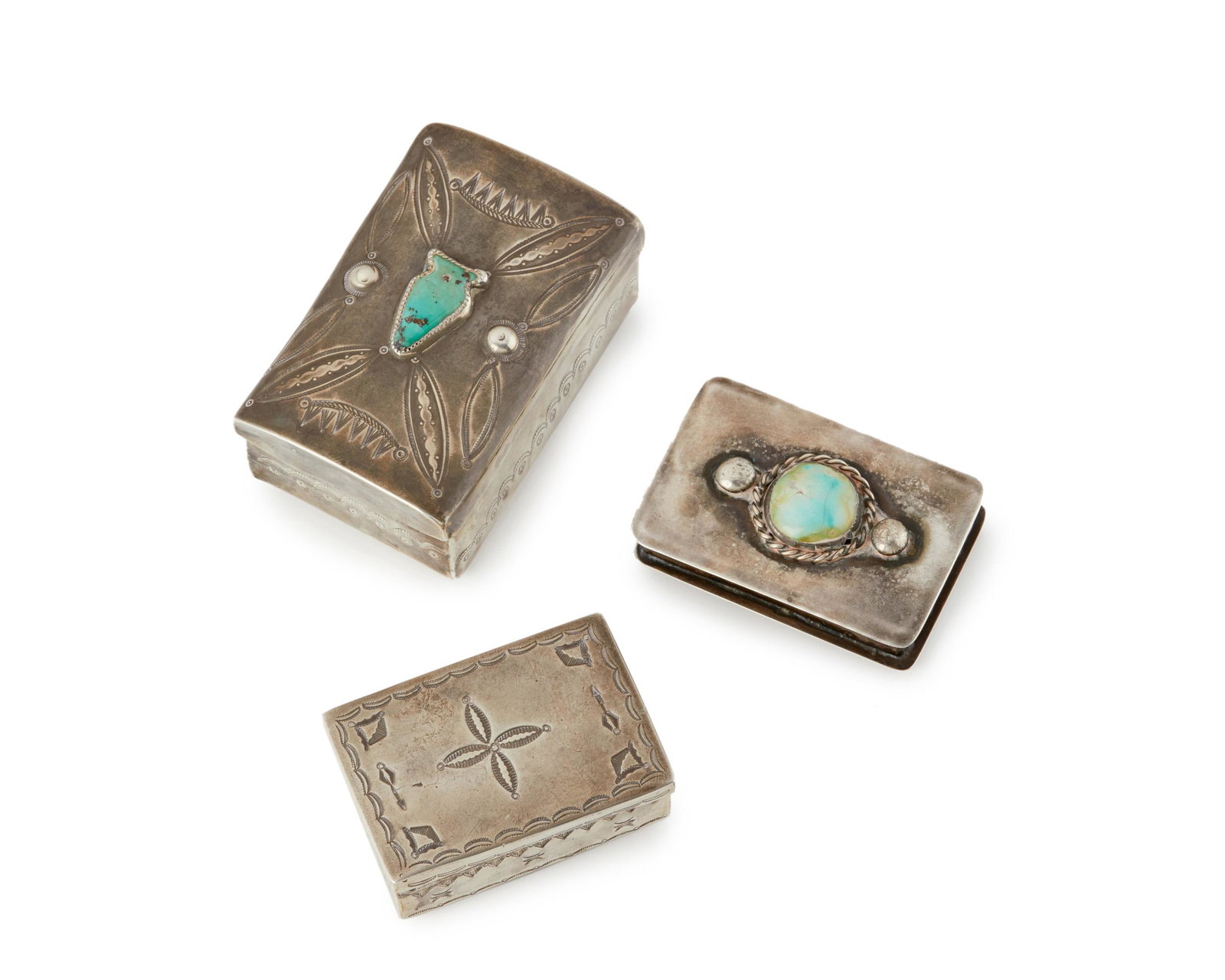 Three Navajo silver boxes: Three Navajo silver boxes Mid-20th century One signed and marked: JB / Sterling One further inscribed: Navajo, 1939 tribal fair, Santa Fe handmade with stamped designs and two stones set on lids, 3 pi