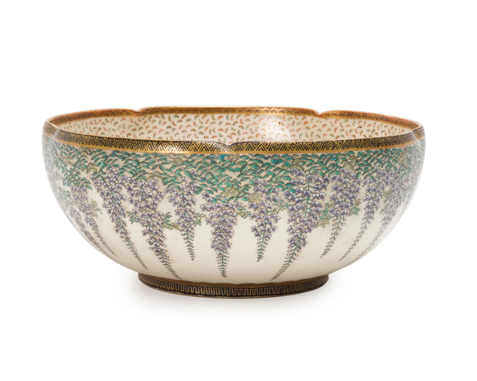 A Japanese Satsuma bowl: Late 19th/early 20th century; Late Meiji era Shimazu crest to bottom The gilt and polychrome-decorated bowl with lobed rim, external wisteria and internal butterfly motif signed in gilt on the bottom 
