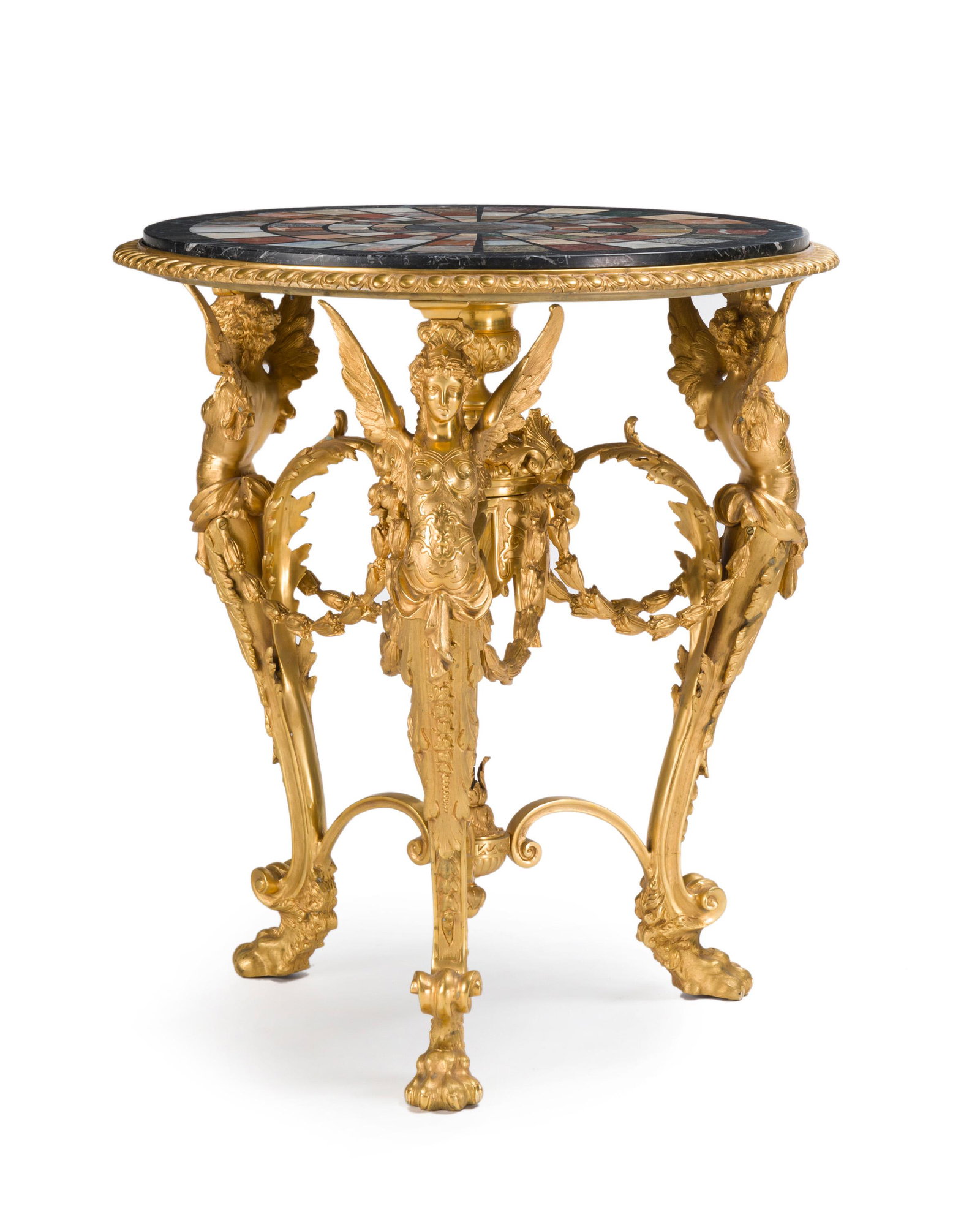 A Continental neo-classical gilt-bronze table: 20th century The marble specimen top over a three-legged base with gilt bronze sphinxes, joined by floral swags and scrolls, raised overall on paw feet 32.325" H x 28.75" Dia.