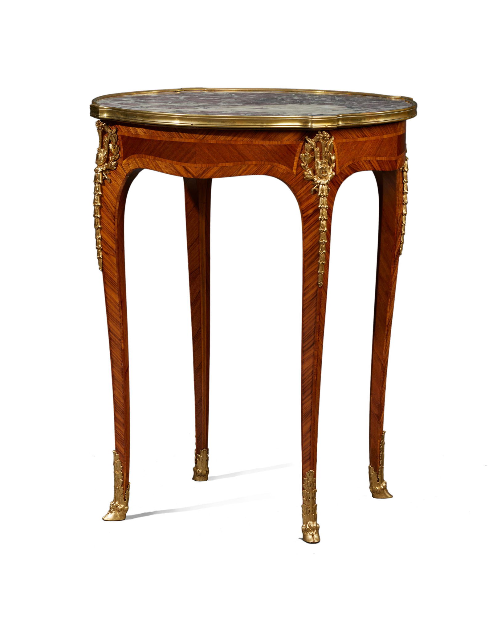 A Francois Linke gilt bronze-mounted gueridon table: Late 19th/early 20th century Signed: F. Linke The marble top over a marquetry apron set with gilt-bronze mount at the top of all four cabriole legs terminating in hoof-form caps 29.5" H x 24.25" Di