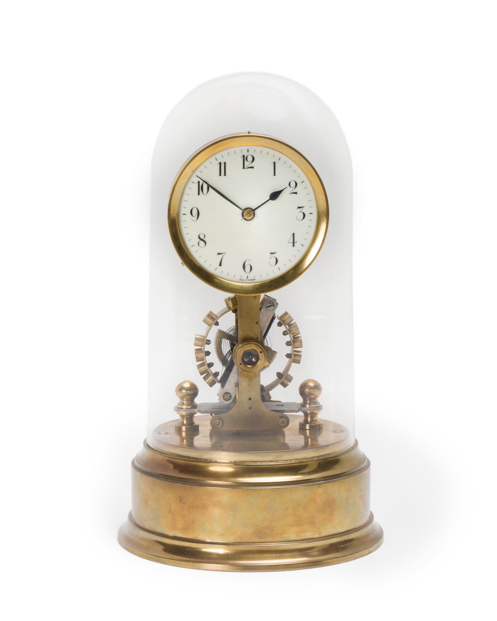 A German Eureka-type electric domed desk clock: First quarter 20th century Marked on dial: Made in Germany Circular white dial with black Arabic hour markers, skeletonized movement with open vertical balance, electric/battery operated, on cylindric