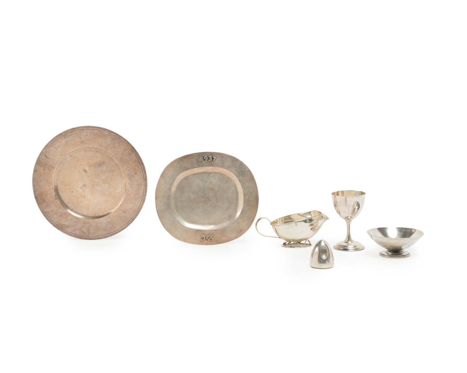 A group of Mexican sterling silver table items: 1930s-1960s; Taxco and Mexico City, Mexico Each stamped for maker; Further stamped: Sterling or 925 Comprising a Los Castillo gravy dish, a William Spratling monogrammed tray, a Conquistador bonbon di
