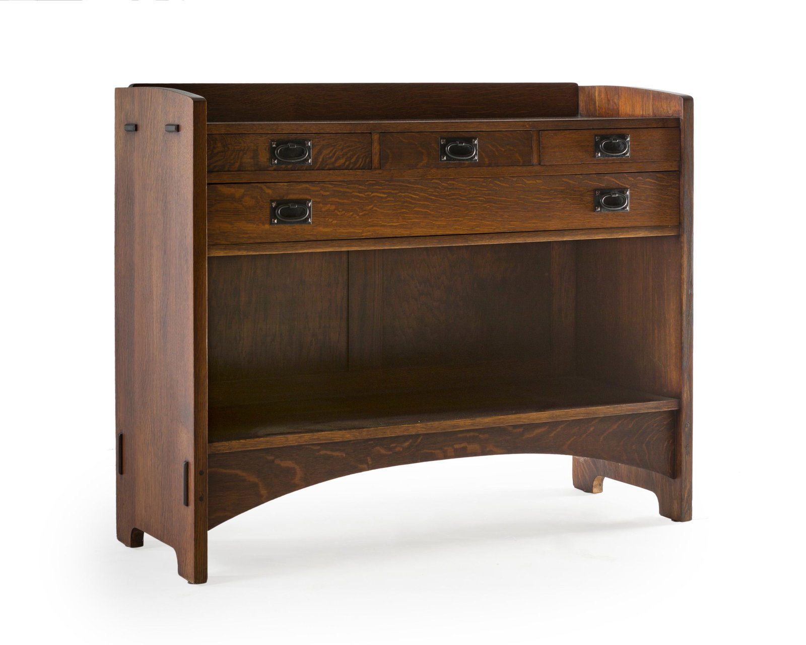 A Gustav Stickley oak serving table, No. 808: 1907-1912 Craftsman paper label verso; Further stamped with the red Craftsman Worksman mark The Craftsman fumed oak table with rectangular top over an arrangement of three short drawers and one long d