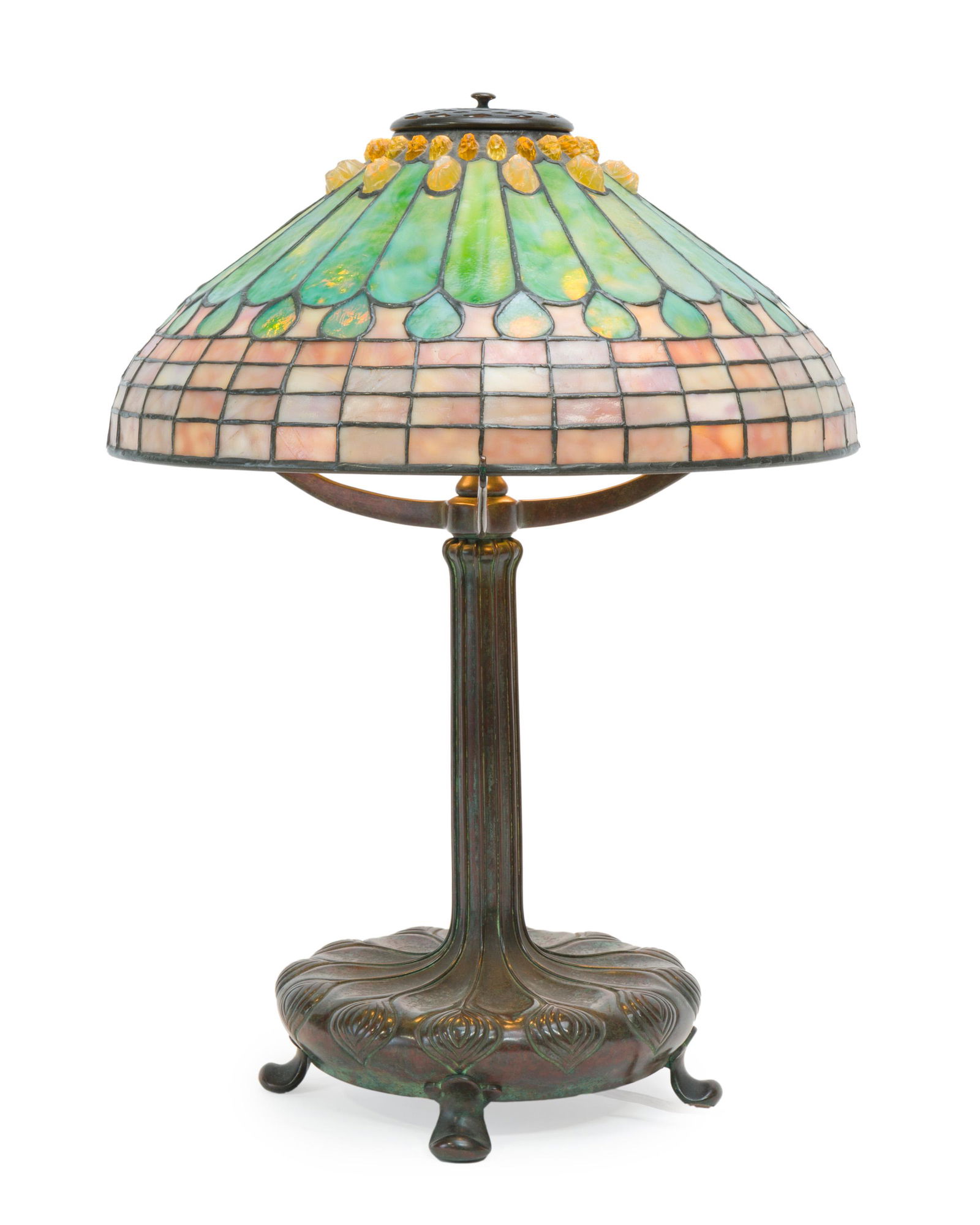 A Tiffany Studios leaded glass and bronze table lamp: First-quarter 20th century Stamped to underside of base: Tiffany Studios / New York / 9925 The dichroic Tiffany leaded glass shade in "Jewel Feather" and "Peacock" motifs with inset glass chunks rai