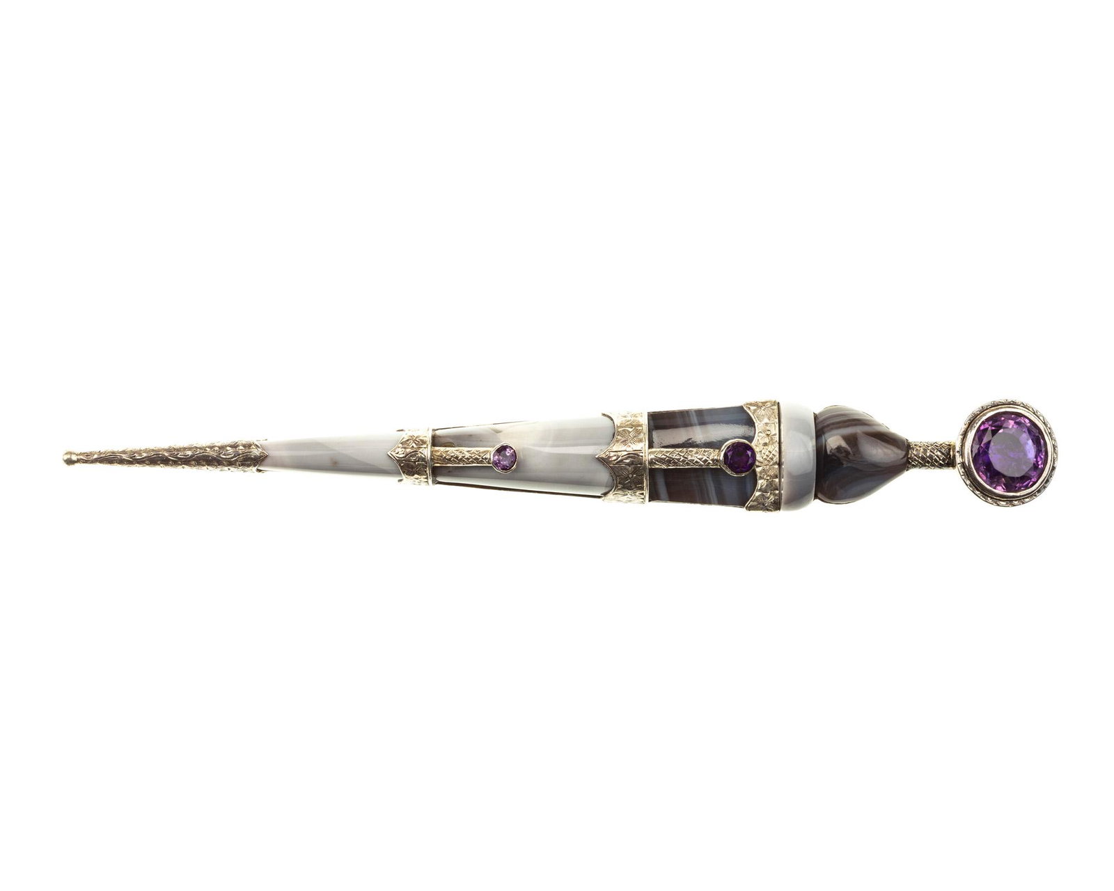 An Antique silver and gem-set "Scottish pebble": Circa 1865 Set with five fancy-shaped grey agates and three amethysts with engraved silver mounts 6 3/8" L 45.5 grams