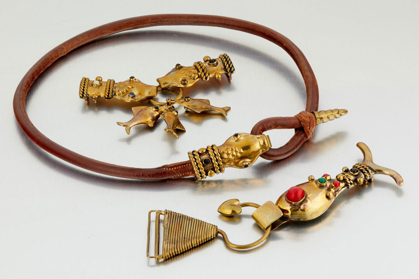 A group of Hubert Harmon accessories: 1942-1948; Taxco Mexico Each stamped for Hubert Harmon; Further stamped: Mexico Comprising a leather belt with serpent head and tail clasp (27" L x 1.25" H); A double stone set serpent head and fish